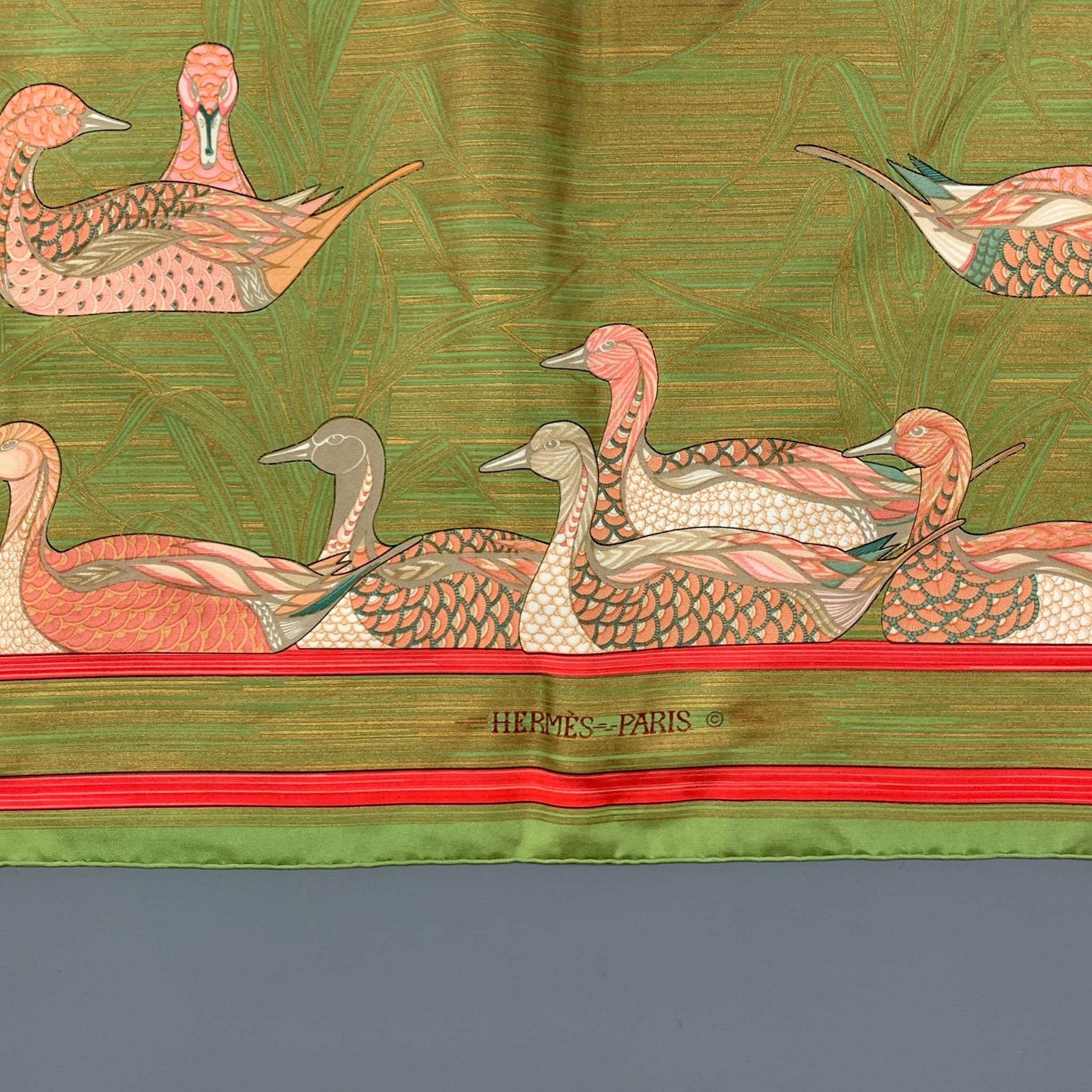 HERMES 'LA MARE AUX CANARDS' Designed by Daphne Duchesne in 1981 scarf comes in a green & pink print silk. Made in France. 

Very Good Pre-Owned Condition. Light marks. As-Is. 

Measurements:

36 in. x 35 in. 