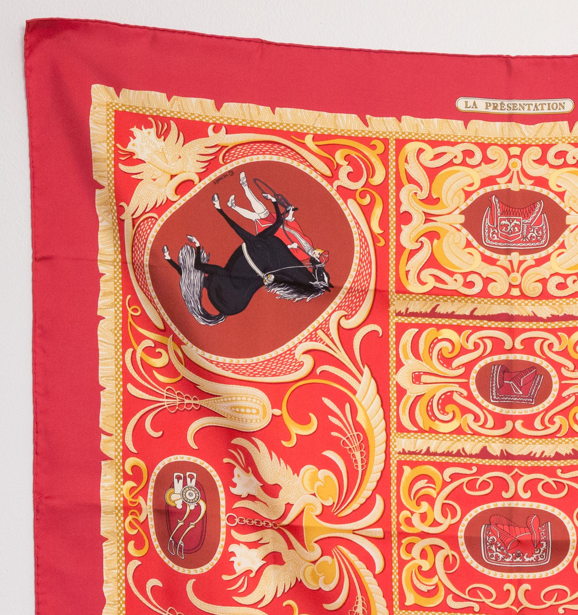 Hermes silk scarf La Presentation by Christiane Vauzelles featuring a red border.
Circa 1978
In good vintage condition. Made in France.
35,4in. (90cm)  X 35,4in. (90cm)
We guarantee you will receive this  iconic item as described and showed on