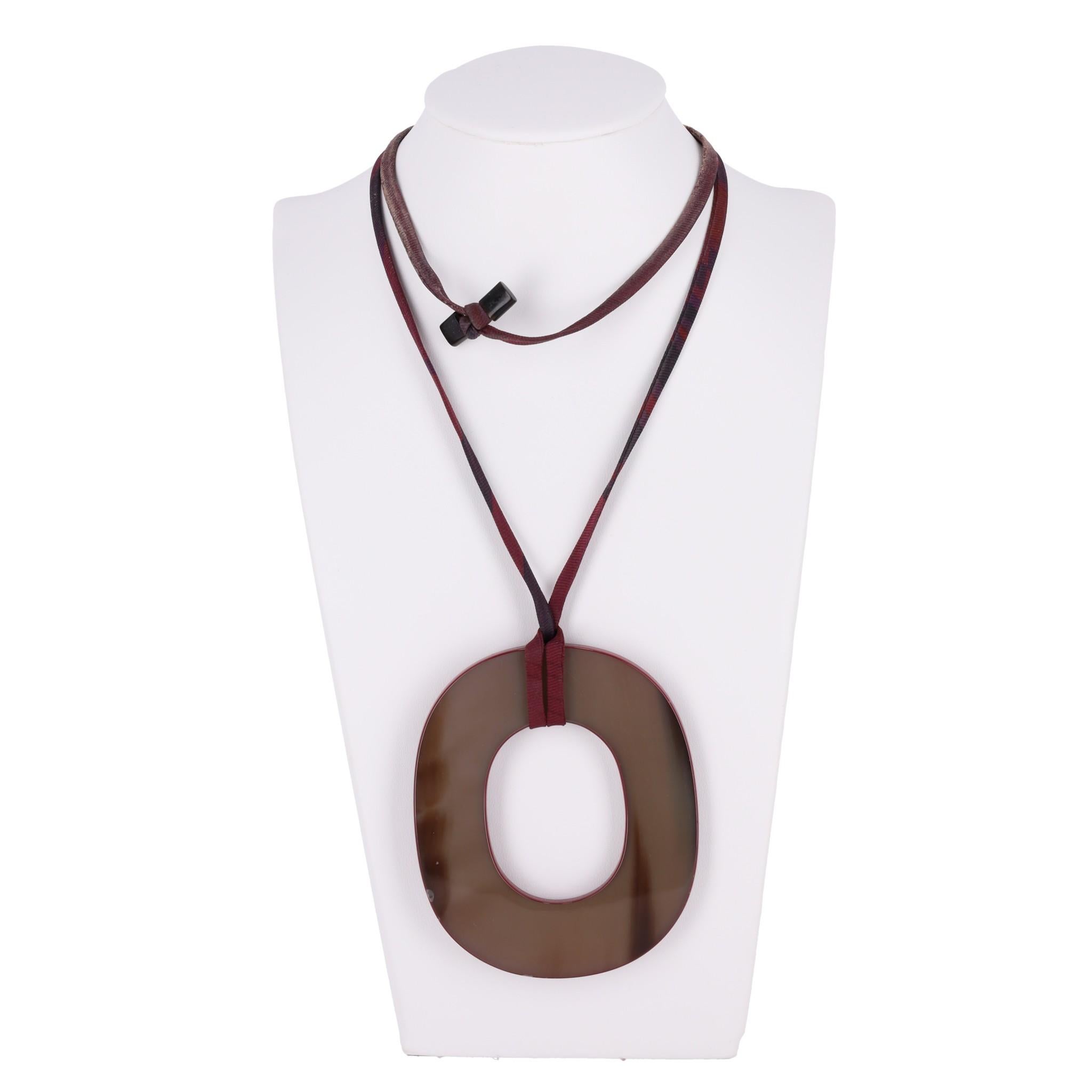 Hermes Lacquered Buffalo Horn Isthme Pendant Necklace

Large ring dis pendant in brown/burgundy lacquered buffalo horn.

Featuring adjustable fabric cord and 'Hermes' engravement.

Size – One Size

Condition – Good/Very Good (Scratches to the