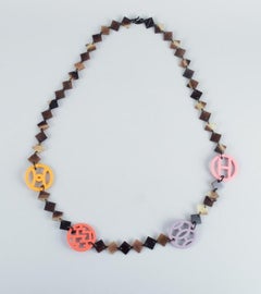 Hermes. Lacquered horn necklace with colored logo details.
