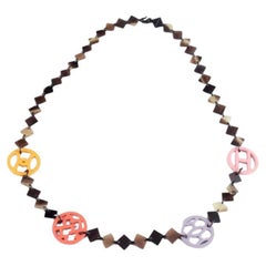 Hermes. Lacquered horn necklace with colored logo details. 