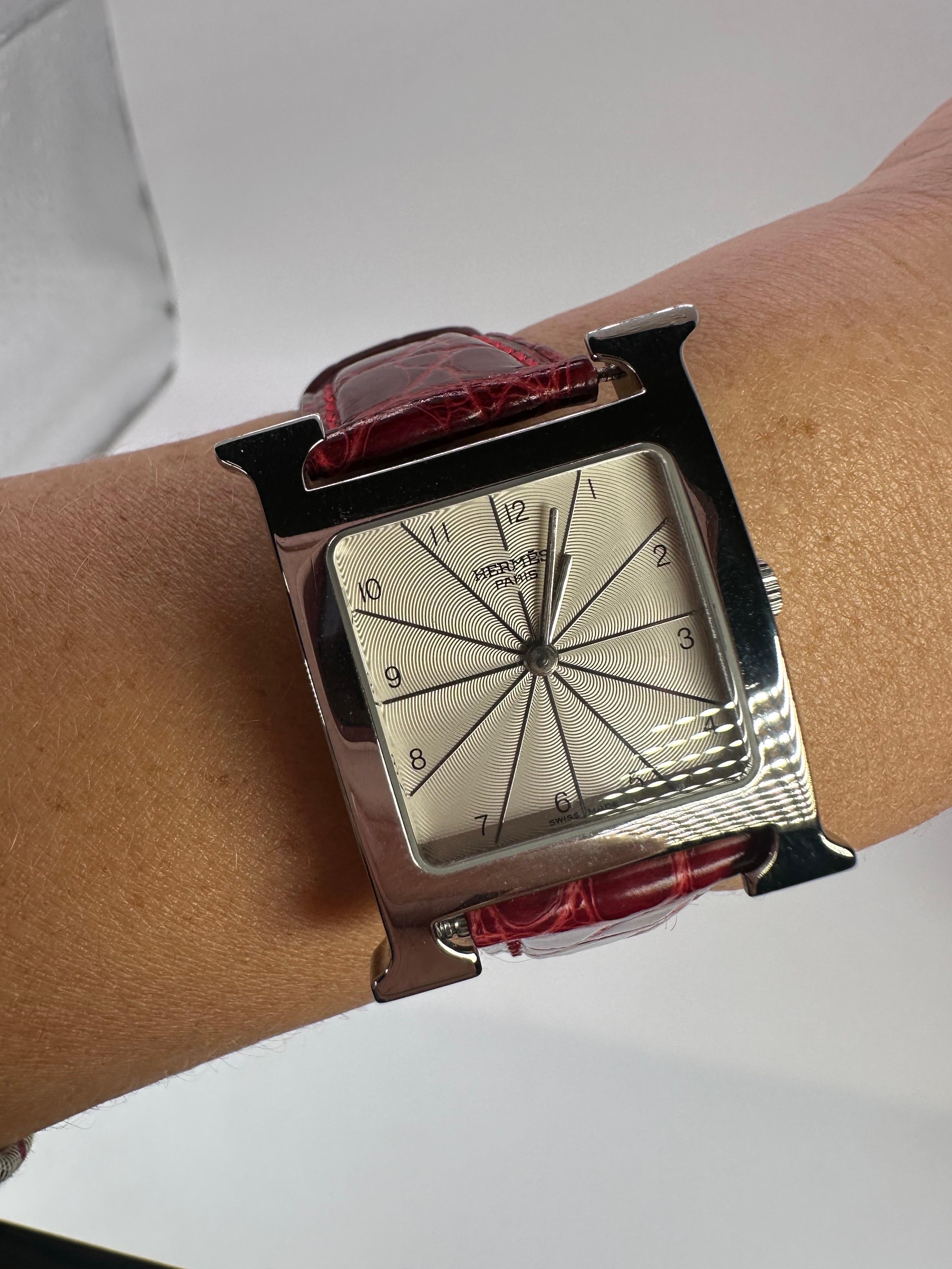 Hermes elegant watch made in stainless steel, the strap is aftermarket in red leather.
Beautiful quartz watch 100% authentic! Please note if you want the strap changed its possible to order from hermes and change it to any color.

WHAT YOU GET AT