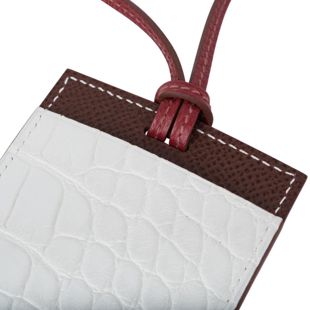 Mightychic offera an Hermes Petite h Lanyard card holder.
Unicorn colour Nuage (Cloud) Porosus Crocodile and brown Epsom leather.
Cardholder has a slot on each side and a thin rouge leather strap.
Comes with signature Hermes box and Cites.
New or