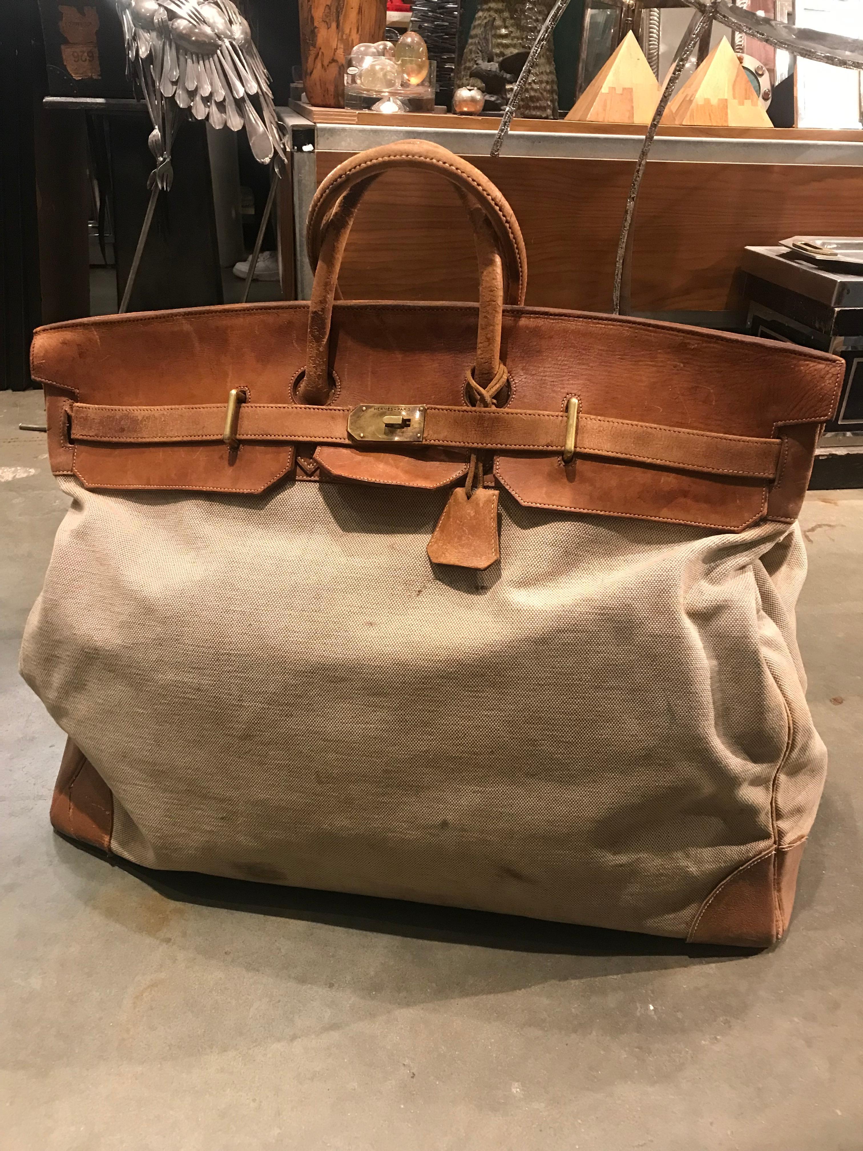 An incredible example of the largest Hermes travel bag ever made. Worn to perfection with a few blemishes, but remaining solid in it's structure and the integrity of the bag. Measures: 60cm,

circa 1960s.