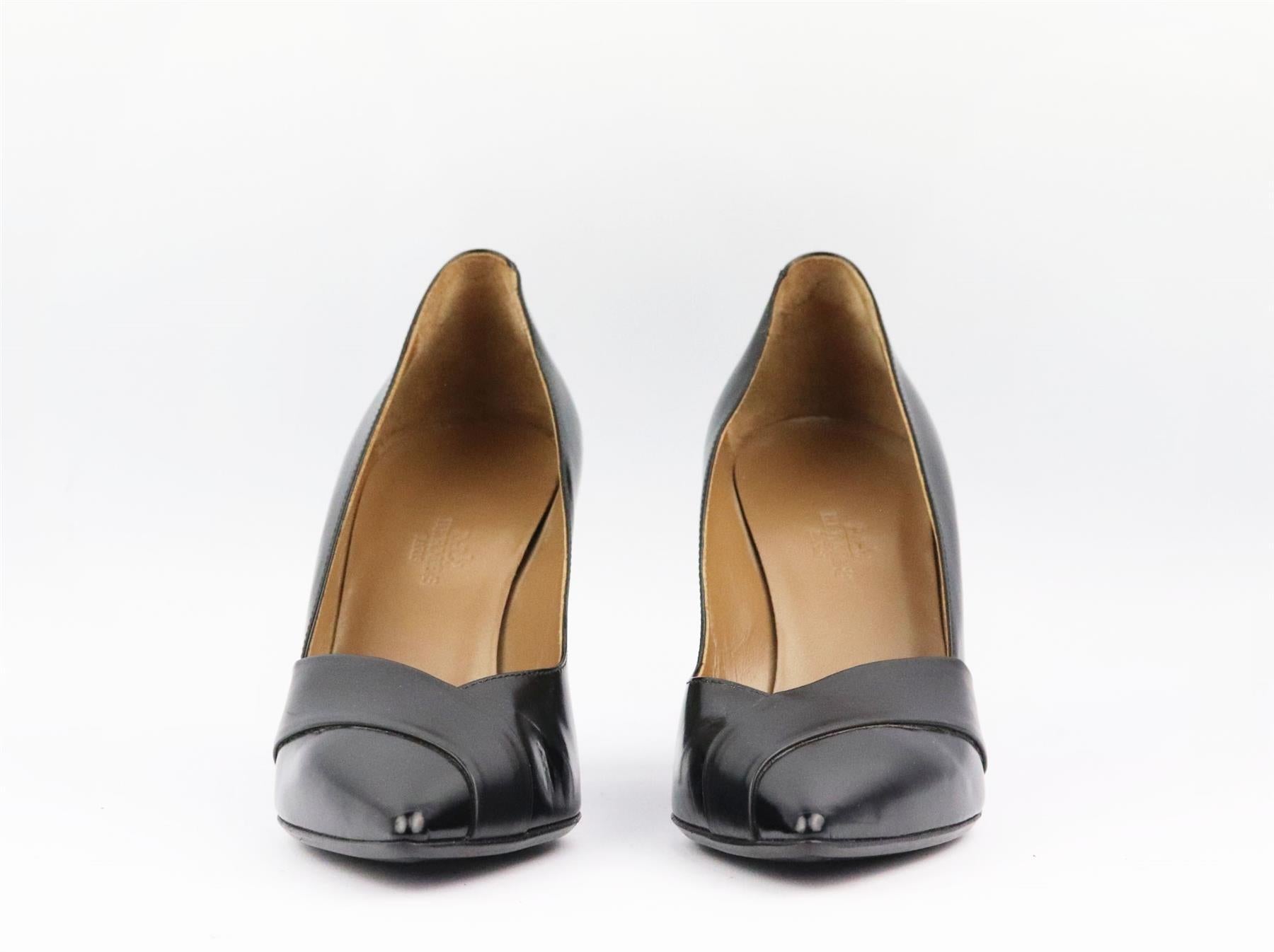 These pumps by Hermès are a classic style that will never date, made in Italy from supple black leather, they have sharp pointed toes and deep v to take you from morning meetings to dinner with friends. Heel measures approximately 63 mm/ 2.5 inches.