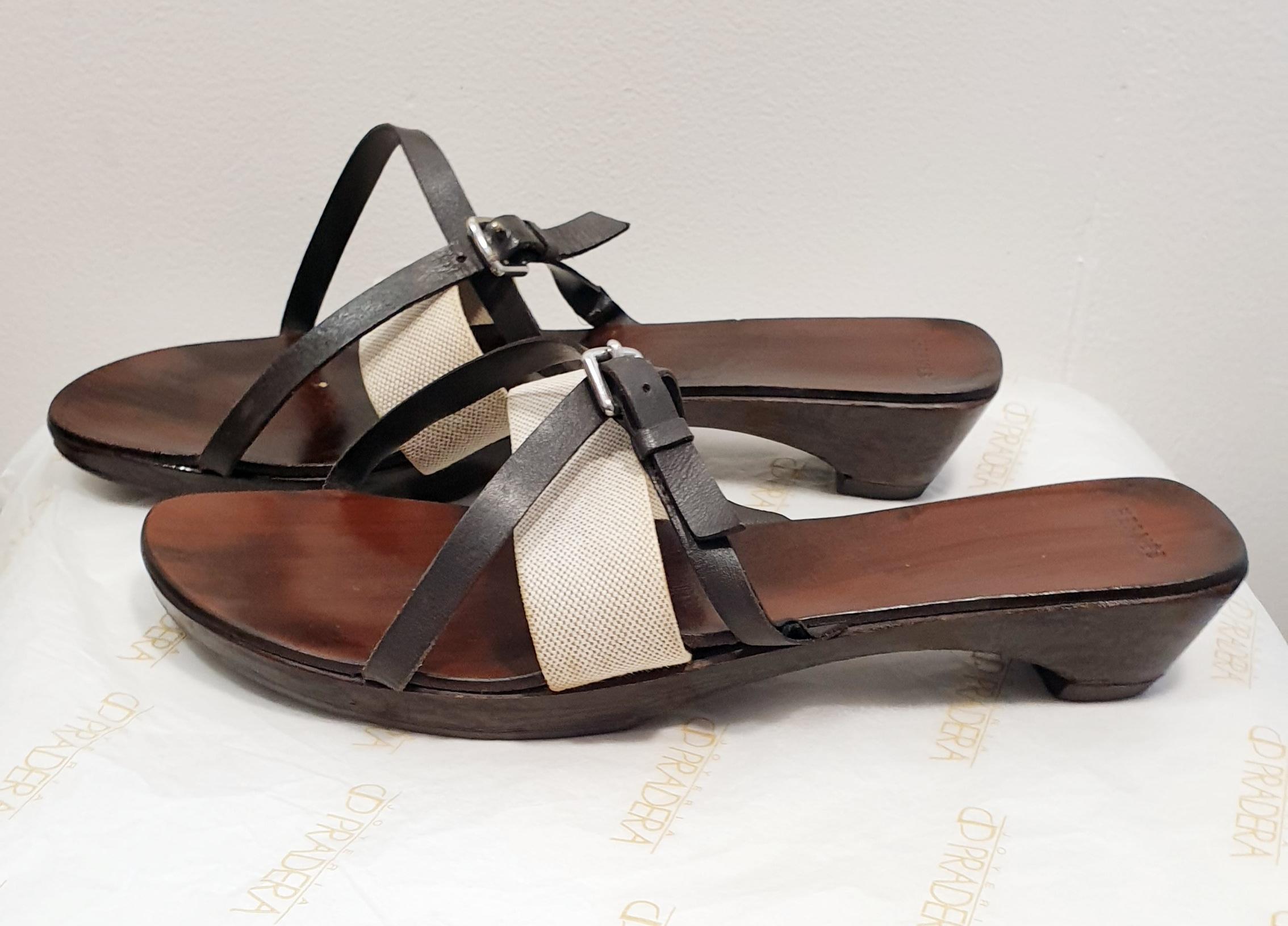 Hermes Leather Sandals
Ebony colored wooden slippers with small heel and strap in beige canvas and leather
SIZE 39
USA SIZE 9

Our Company Fashion Division  is specialized in European Fashion designers, clothing, handbags, accessories and as such we