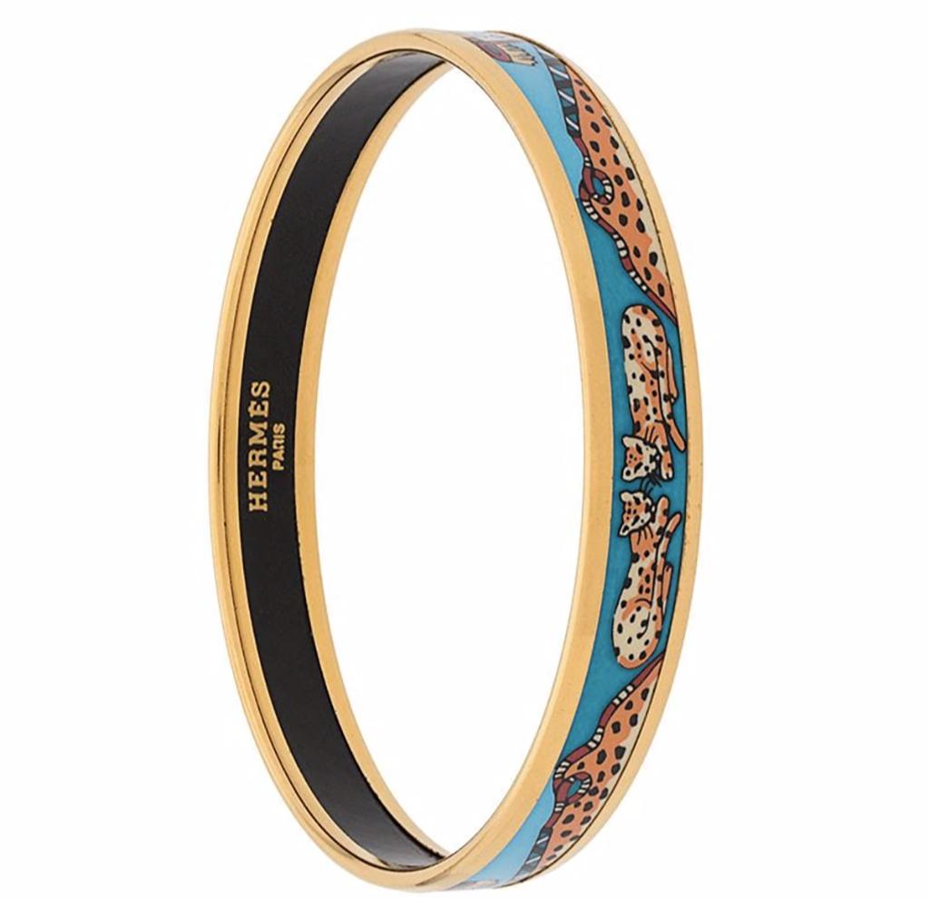 Hermes enamel blue and gold-tone plated metal leopard pattern bangle featuring an internal logo stamp and a leopard pattern. 
In excellent vintage condition. Made in France.
2.3in. (6cm)  X 0.39in (1cm)
We guarantee you will receive this gorgeous
