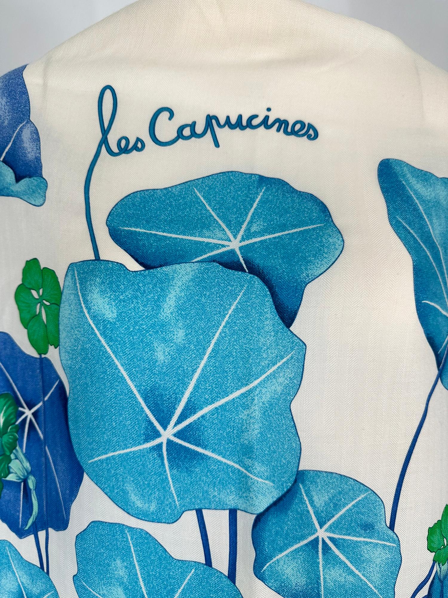 Rare to find Hermes Les Capucines GM 140  by Antoine de Jacquelot in cream, blues and greens 65% cashmere & 35% silk shawl. Cream ground with blue nasturtiums twining throughout. Lovely large scale flowers. In excellent unused condition, with
