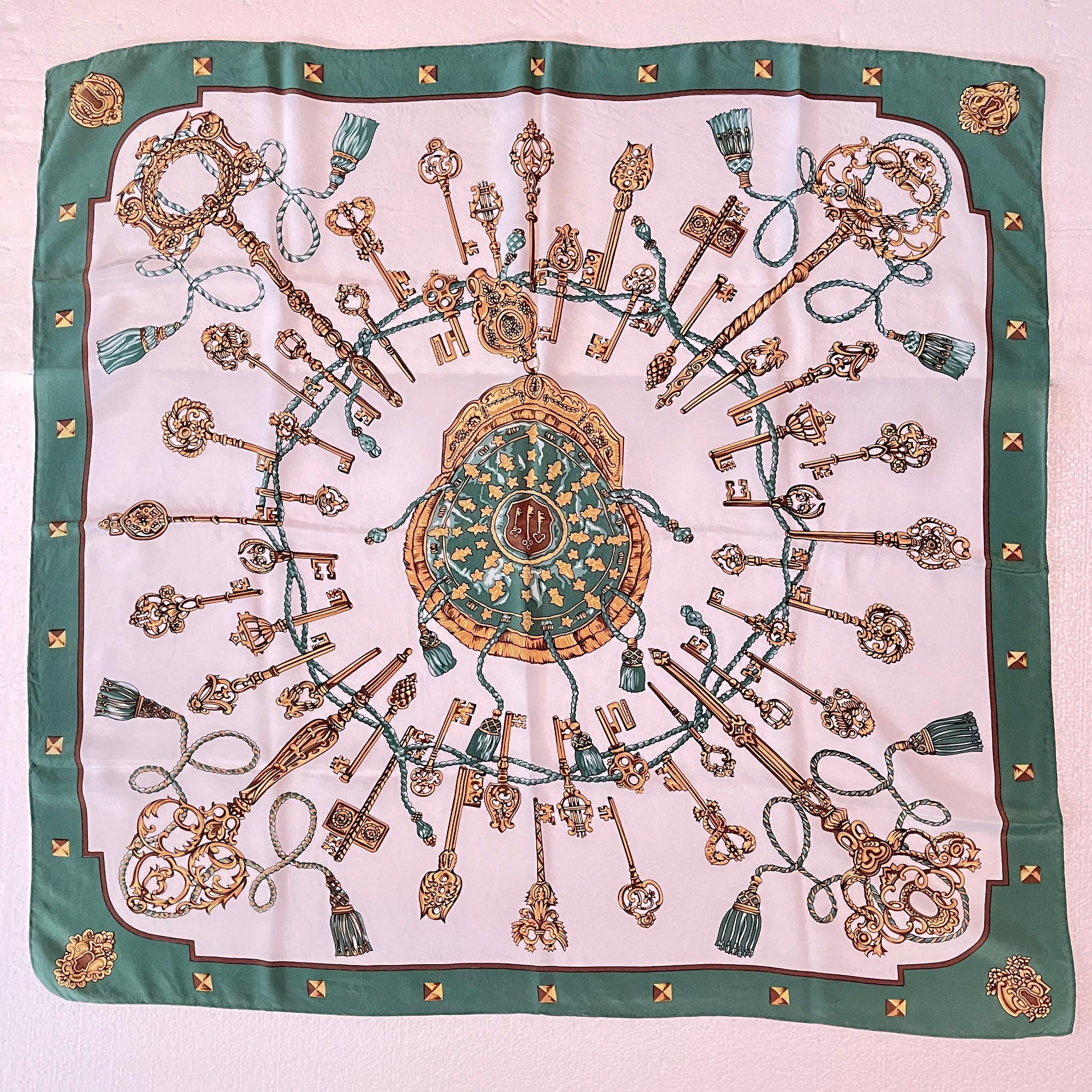 Vintage Hermès Silk Scarf, Les Clés designed by Caty Latham, first issued in 1965.

This ‘Keys’ scarf is an early issue with a Jade green border, and showing interlocking gold keys, rope, and tassels surrounding a central cartouche of a hanging