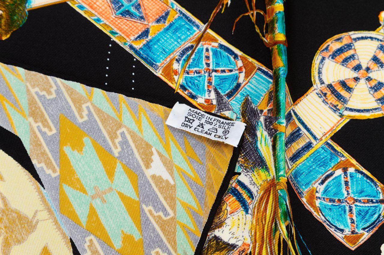 Hermès Les Danses des Indiens is in 100% silk twill, with hand rolled edges. Designed by coveted US artist, Kermit Oliver. Rare and collectible black colorway.