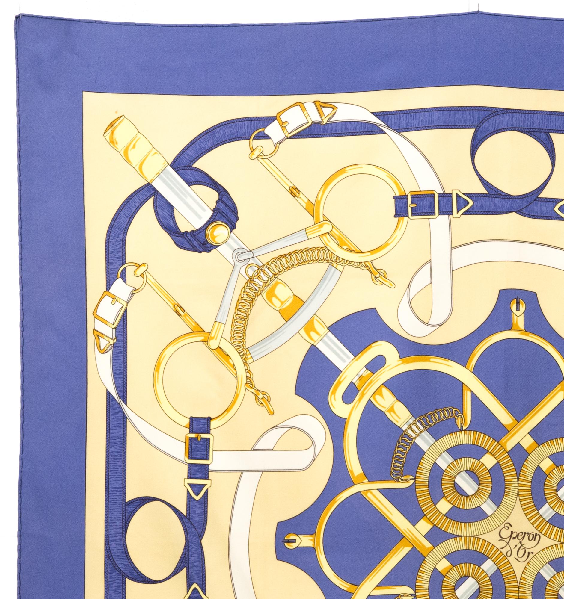 Hermes silk scarf « Les Eperons d’Or»  by Henri d'Origny   featuring a blue border, a Hermès signature. 
Circa 1989
In good vintage condition. Made in France.
35,4in. (90cm)  X 35,4in. (90cm)
We guarantee you will receive this  iconic item as