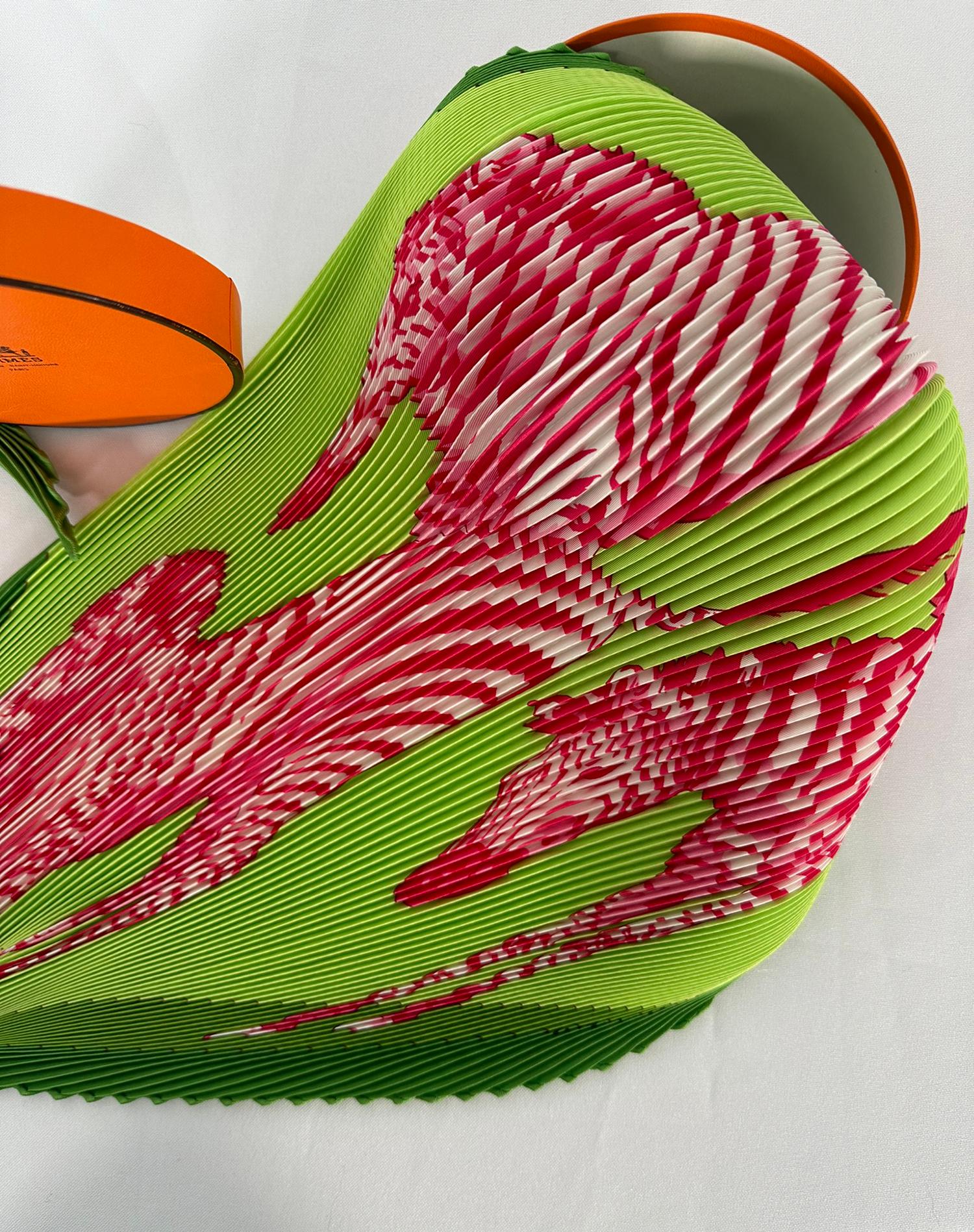 Hermes discontinued plisse scarves in 2012. This most-coveted, Hermès Les Zebres II, silk twill plisse scarf features leaping zebras in brilliant pink and white against a lush lime green background, all set off by a rich grass green border. Designed