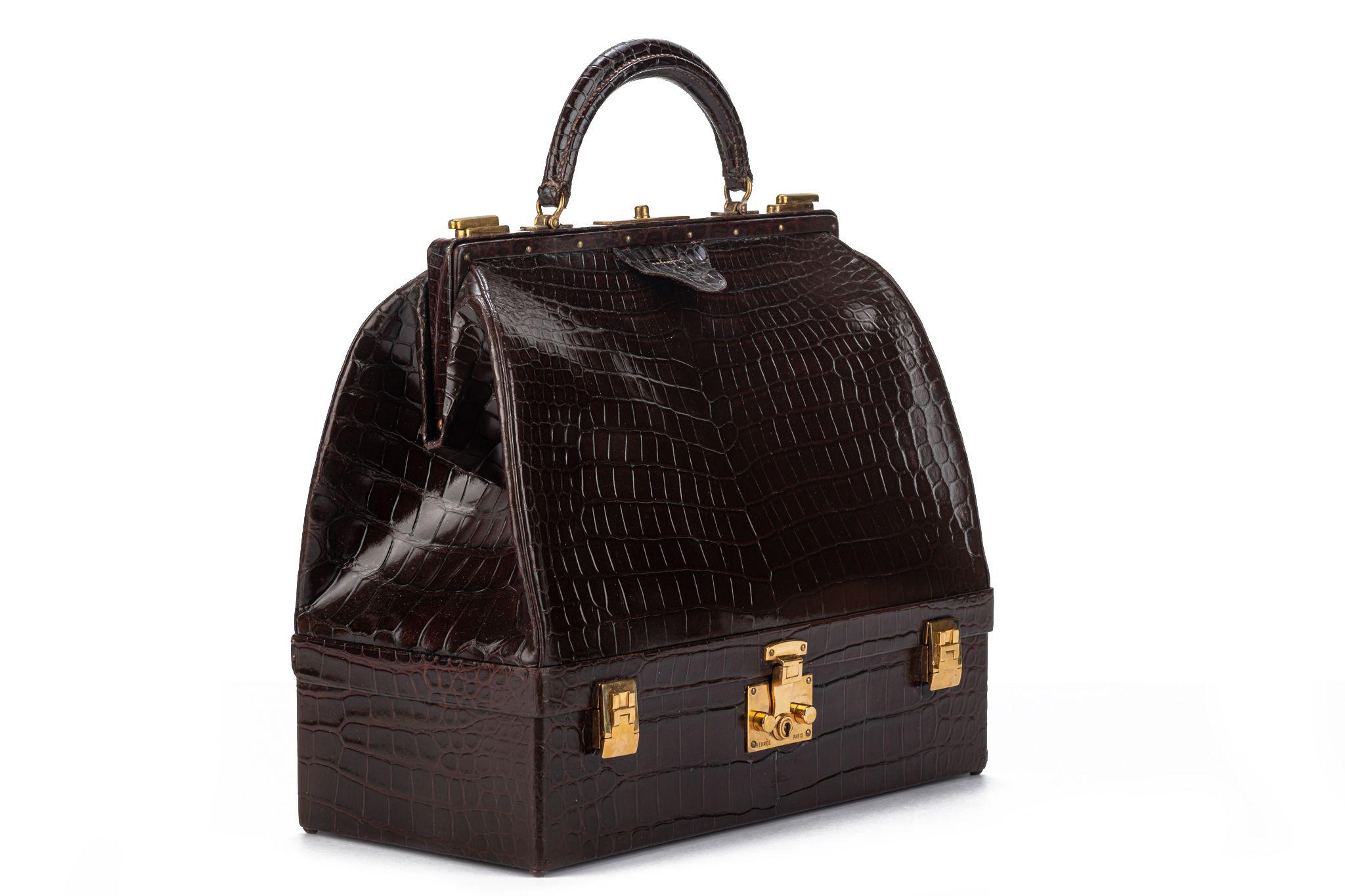 Hermes rare and collectible large doctor’s bag in brown shiny croc, lined in brown leather and caramel velvet, gold tone hardware. Dates back to the 50s , pre date stamp. Handle drop 2.5”. Recently received spa service. 
Original box. No cites .
