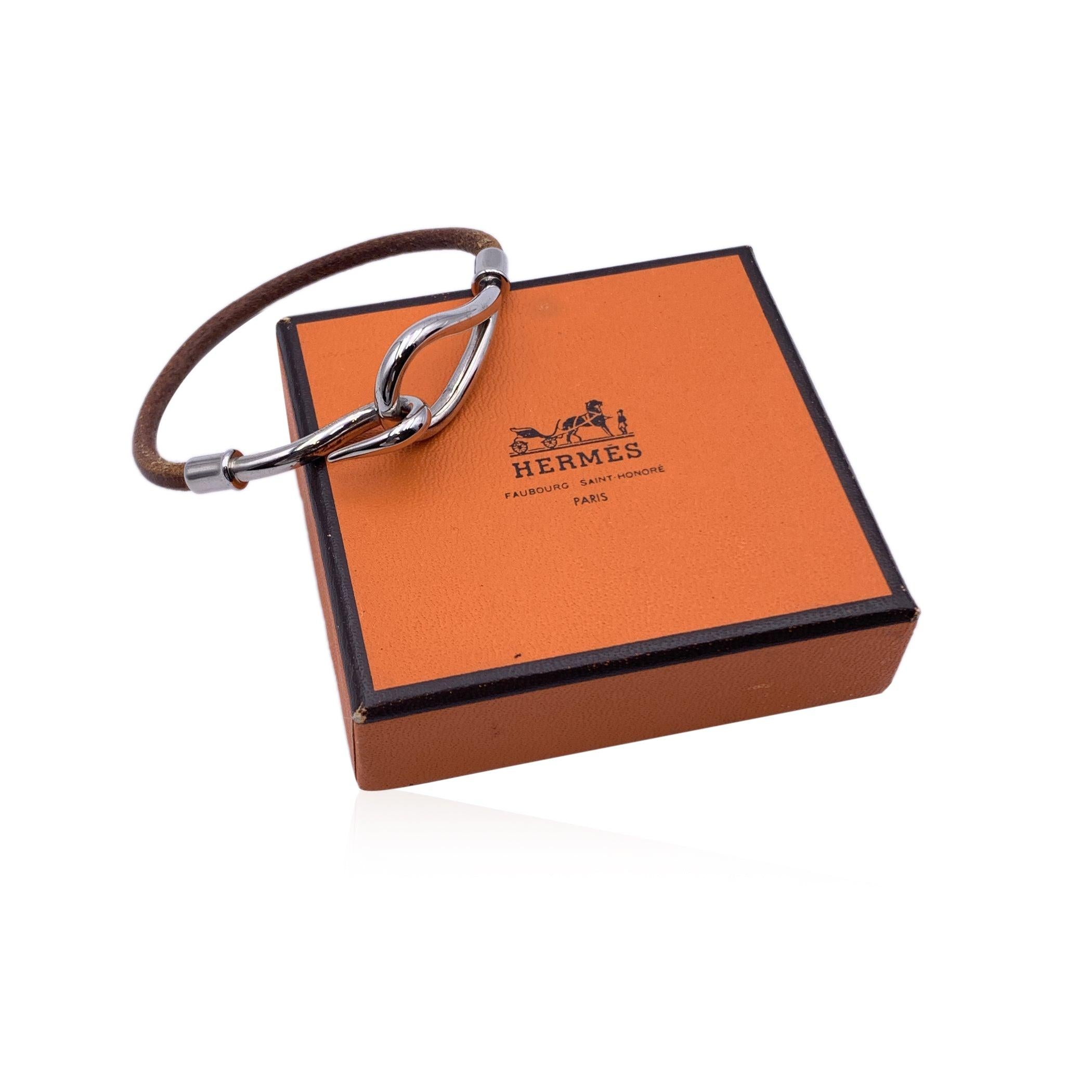 Hermes 'Jumbo Hook' Single Bracelet. Brown leather string with silver metal hook closure. Long Approx. 6.5 inches - 16.5 cm including hook. Hermes logo on hook. Condition A - EXCELLENT Gently used.Please, look carefully at the photos and ask for any