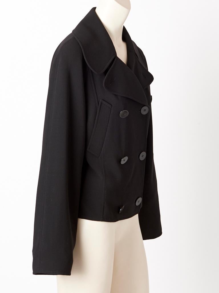 Hermès, black, mixed fibers, double breasted, cropped, unlined pea coat, having a wide notched collar, and slanted, slash, breast pockets.