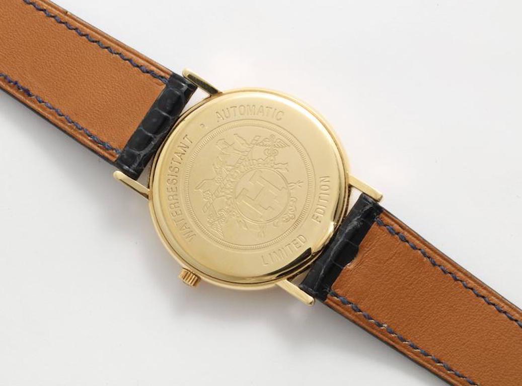 A fabulous Hermès wrist watch with diamond numerals on a slate color face and set in 18 k Gold. This watch is rare and very desirable. it is the original alligator strap in the original box