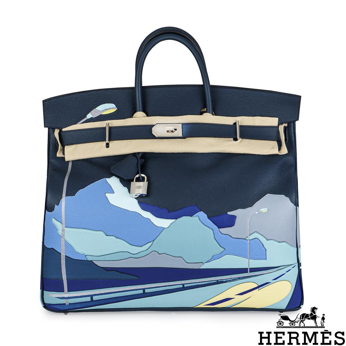 A Limited Edition Hermès Haut A Courries Birkin 50cm handbag. The exterior of this HAC Birkin displays a design of an Endless Road winding through a Californian landscape. It features Togo, Swift and Clemence leather in Bleu de Prusse, complemented