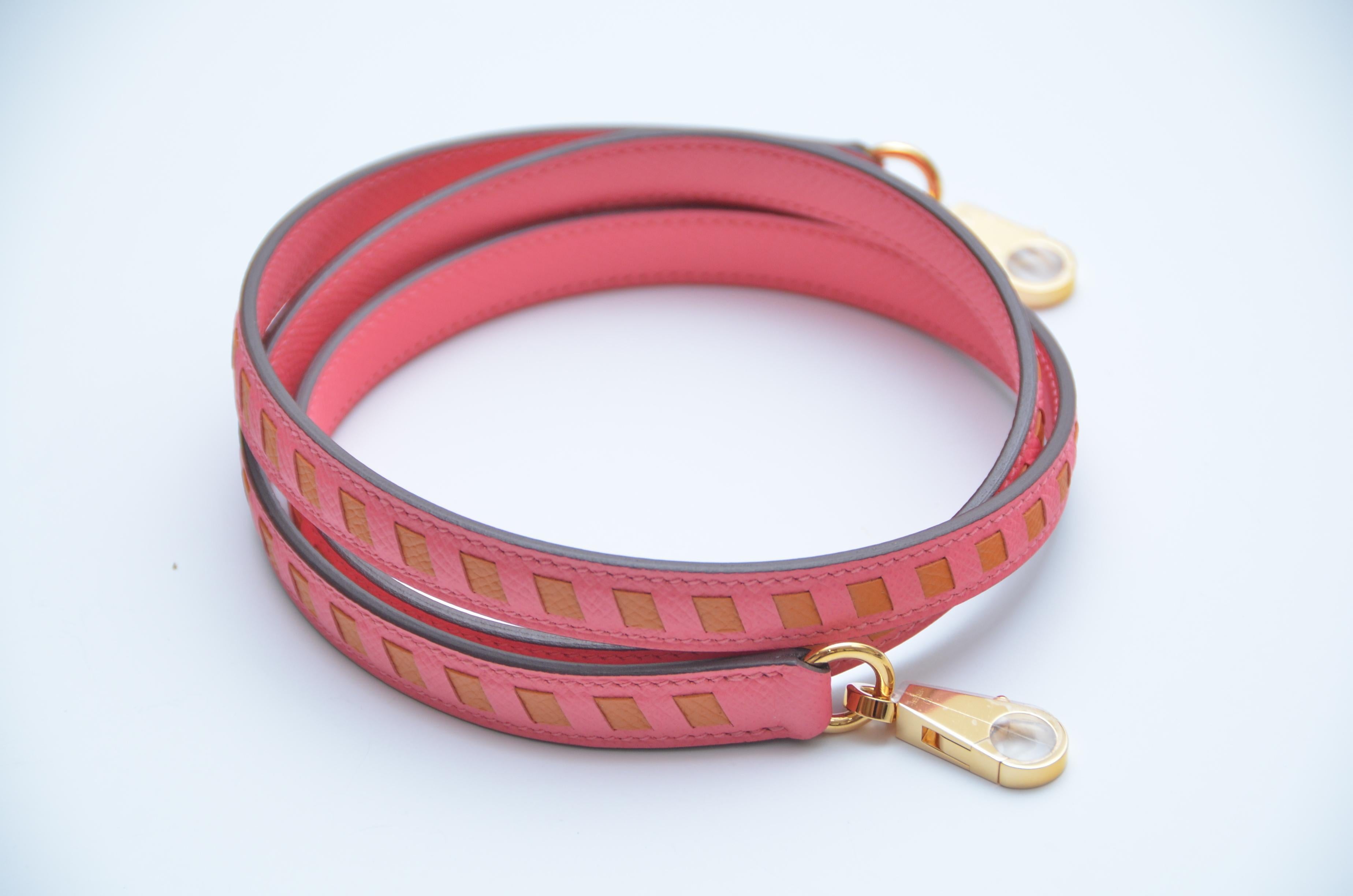 Hermes Limited Edition Handbag Strap 
Color is Rose Azalee X Abricot 
Brand new with dust bag and box.
Clear plastic on the hardware except on one side of the metal clip.approximate length 44” or 112 cm
Possibly lost during photographing.
Made in
