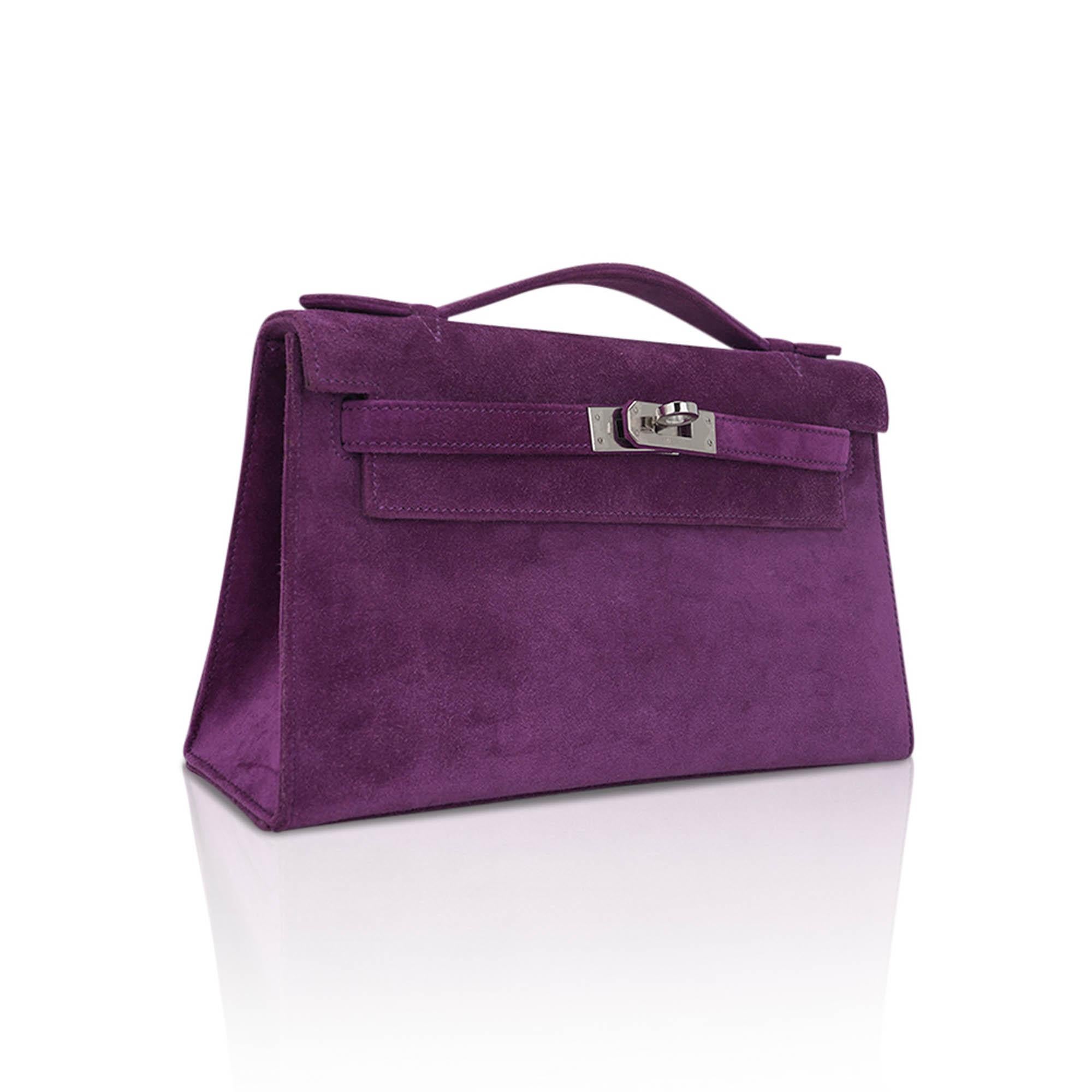 Mightychic offers an ultra-rare and stunning Hermes Kelly Pochette clutch featured in richly saturated Violet Doblis (Suede).
This limited edition Hermes Kelly Pochette suede bag is complimented with palladium hardware.
Signature stamp on