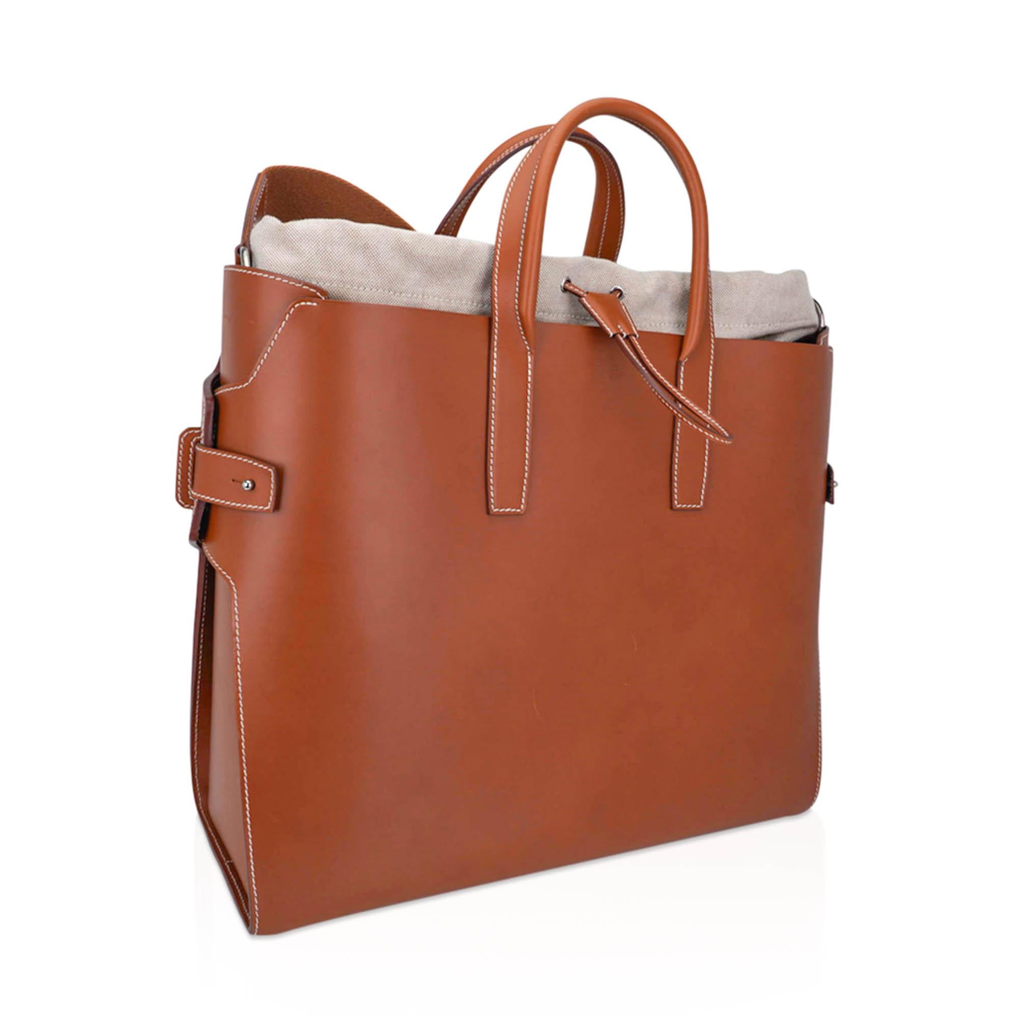 Mightychic offers a rare limited edition Hermes Tote featured in Fauve.
Tote has a detachable Toile insert with canvas shoulder strap.
The bag has Fauve leather handles and Palladium hardware.
Finished with white top stitch all around.
Toile insert