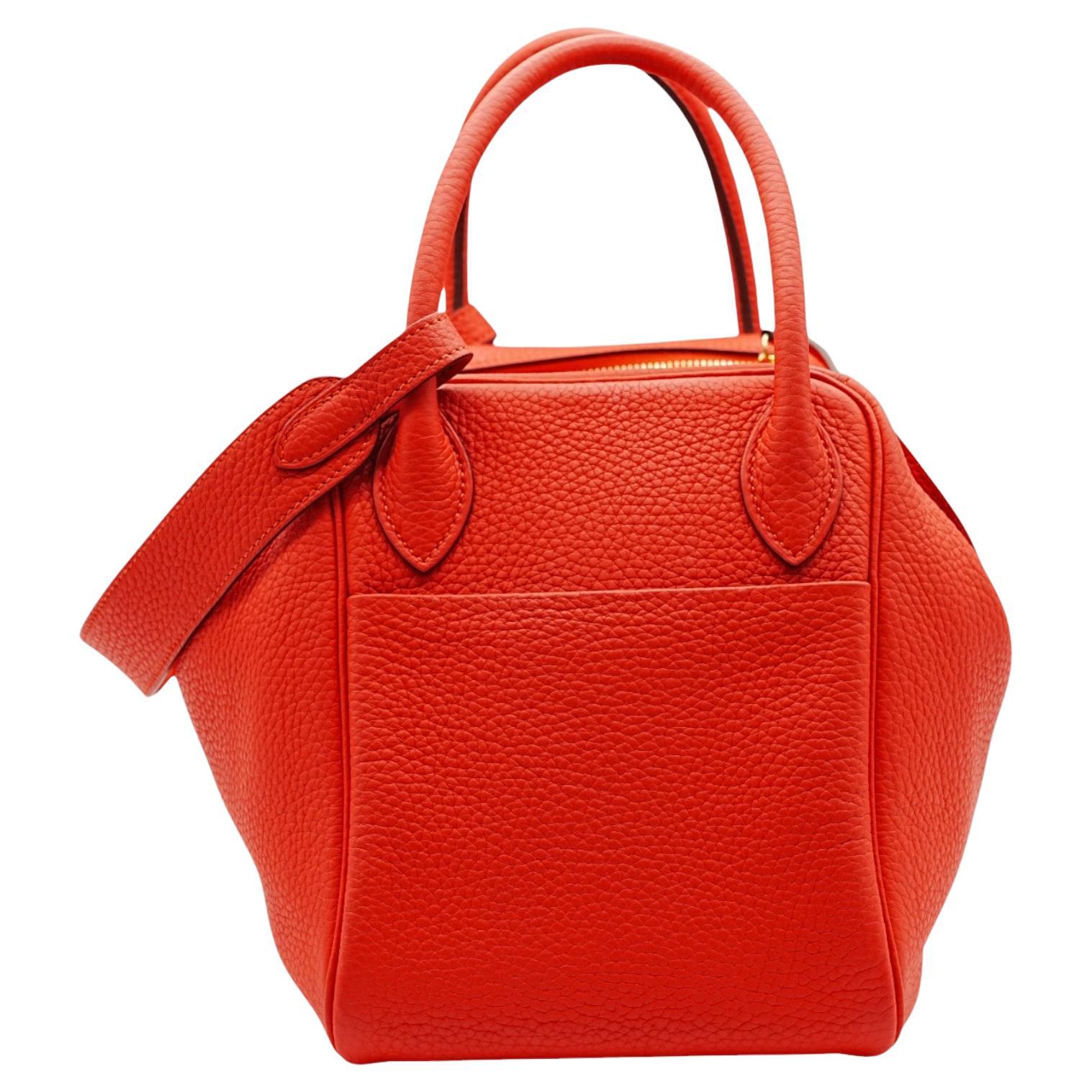 The 2016 Hermès K1 Red Clemence Leather Lindy Shoulder Bag features a vibrant red shade and a supple texture. Designed with dual handles and an additional shoulder strap, it offers both style and versatility, making it perfect for any occasion.
