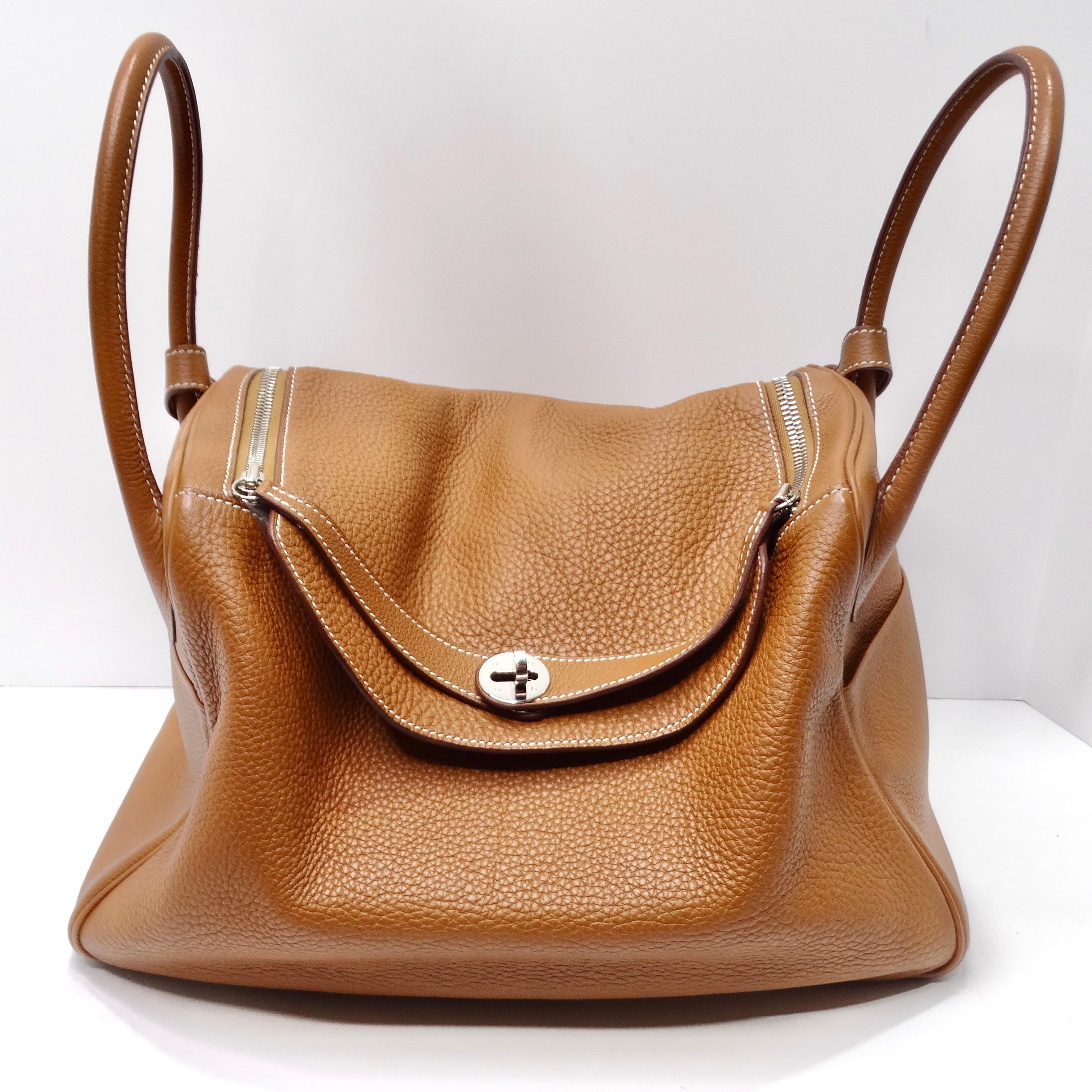 If you're in search of a handbag that seamlessly blends iconic design with unrivaled versatility, your quest ends here. The Hermès Lindy 34 Gold Clemence Leather Shoulder Bag is the embodiment of timeless elegance and adaptability.  The Lindy's