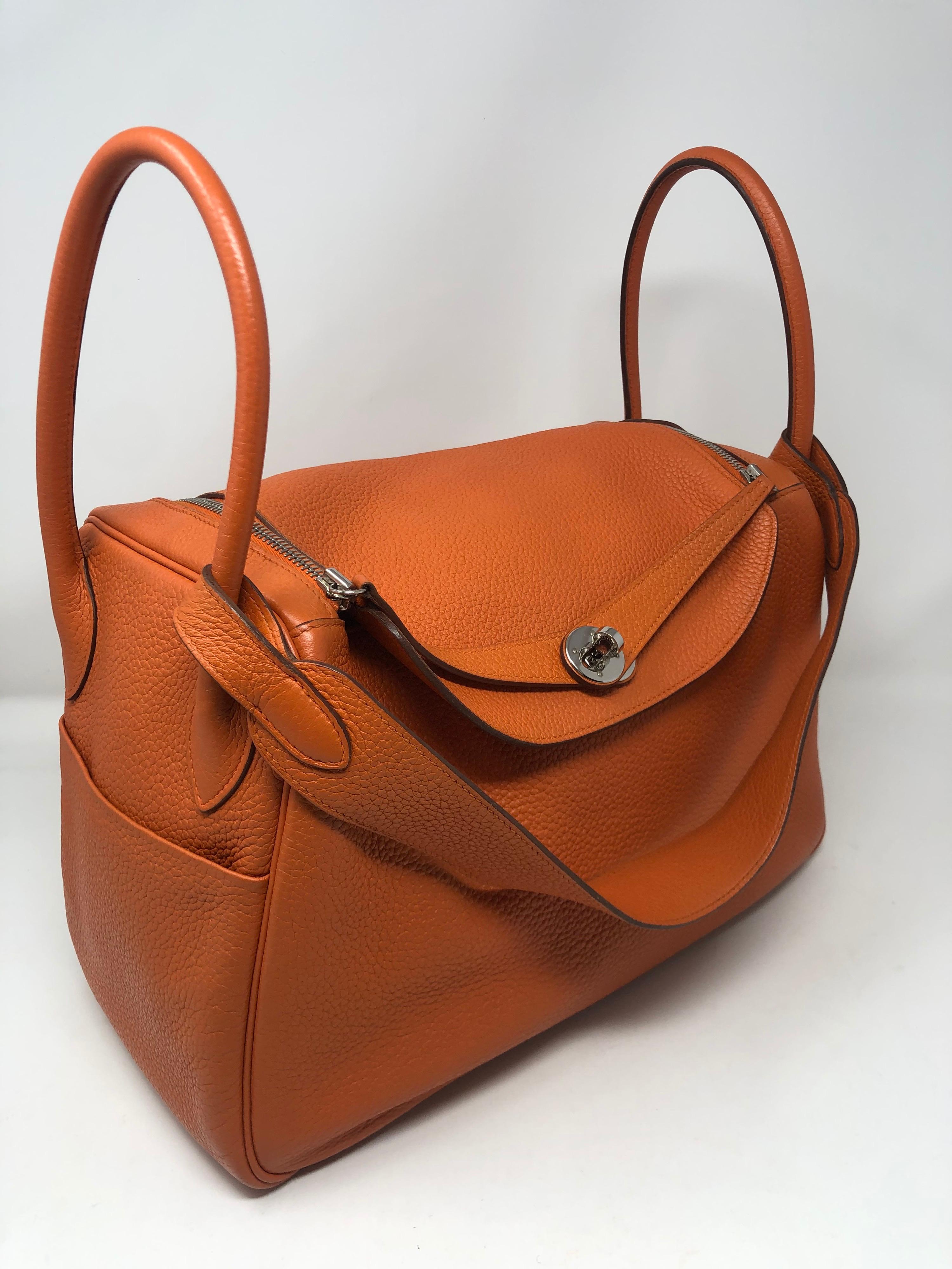 Hermes Lindy 34 Orange Bag. Clemence leather. Palladium hardware. From 2014. R square. Good condition. Beautiful bag. Can be worn 2 ways. Guaranteed authentic. 