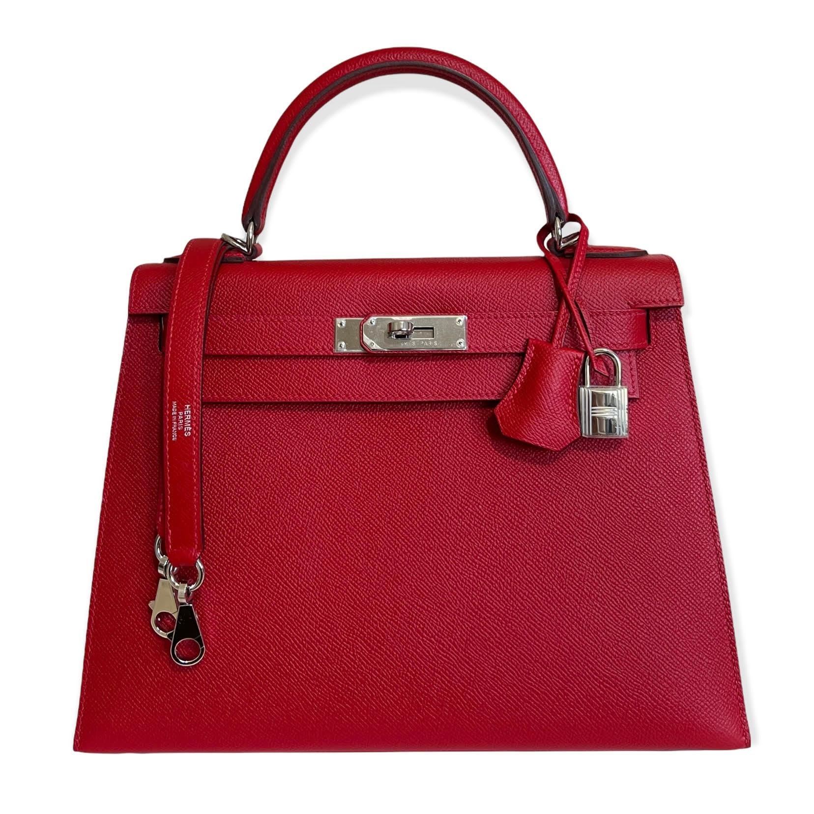 This authentic Hermès Lipstick Red Epsom 28 cm Kelly Sellier is in pristine condition with the protective plastic intact on the hardware.     Hermès bags are considered the ultimate luxury item worldwide.  Each piece is hand sewn with waitlists that