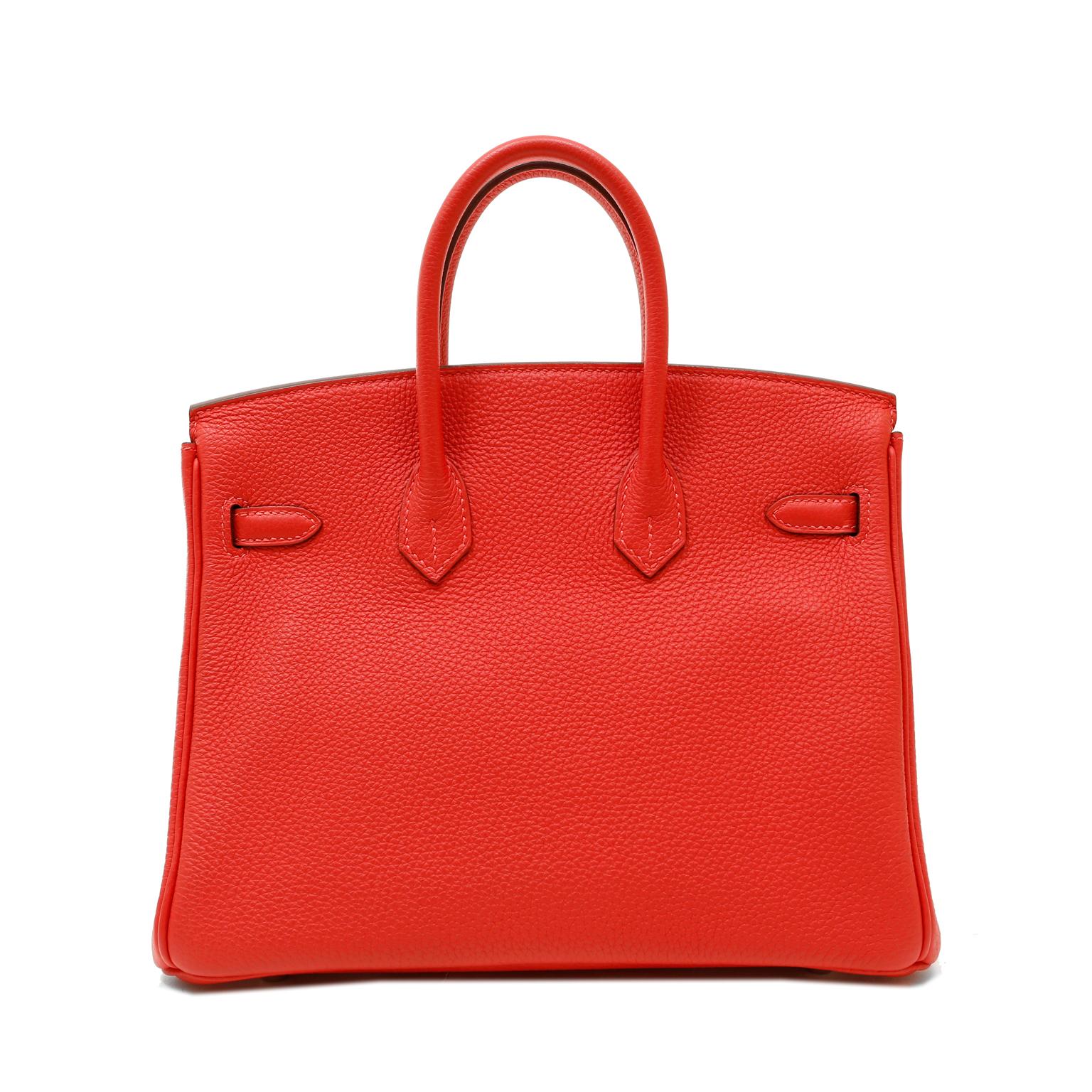 This authentic Hermès Lipstick Red Togo 25 cm Birkin is in pristine unworn condition with the protective plastic intact on the hardware.  Highly sought after in the 25 cm silhouette, this firecracker Birkin is a fabulous collectible.  
Lipstick red