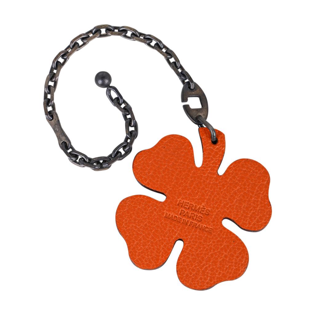 Mightychic offers an Hermes vintage four leaf Lucky Clover key chain featured in Vert Anis and Orange.
Chevre leather on each side creates this fabulous shamrock Hermes accessory.
Sterling silver chain has not been cleaned as some people like the