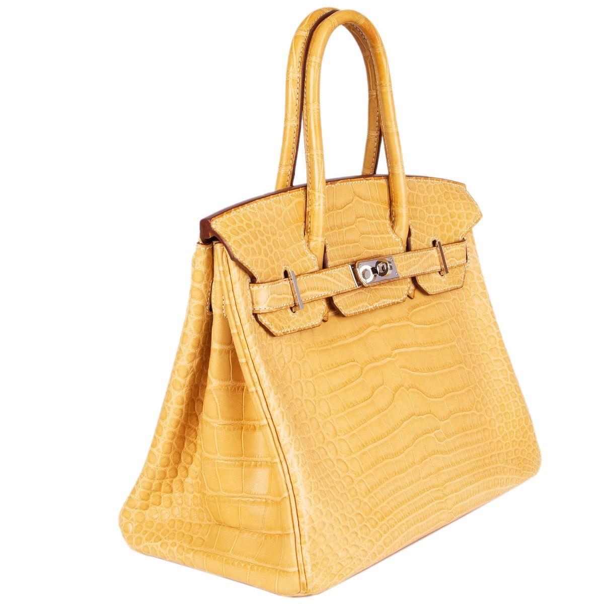 Hermes 'Birkin 30' in Mais (yellow) matte alligator leather. Lined in Chevre (goat skin) with an open pocket against the front and a zipper pocket against the back. Has been carried with very slight patina to underside of handles. Overall in