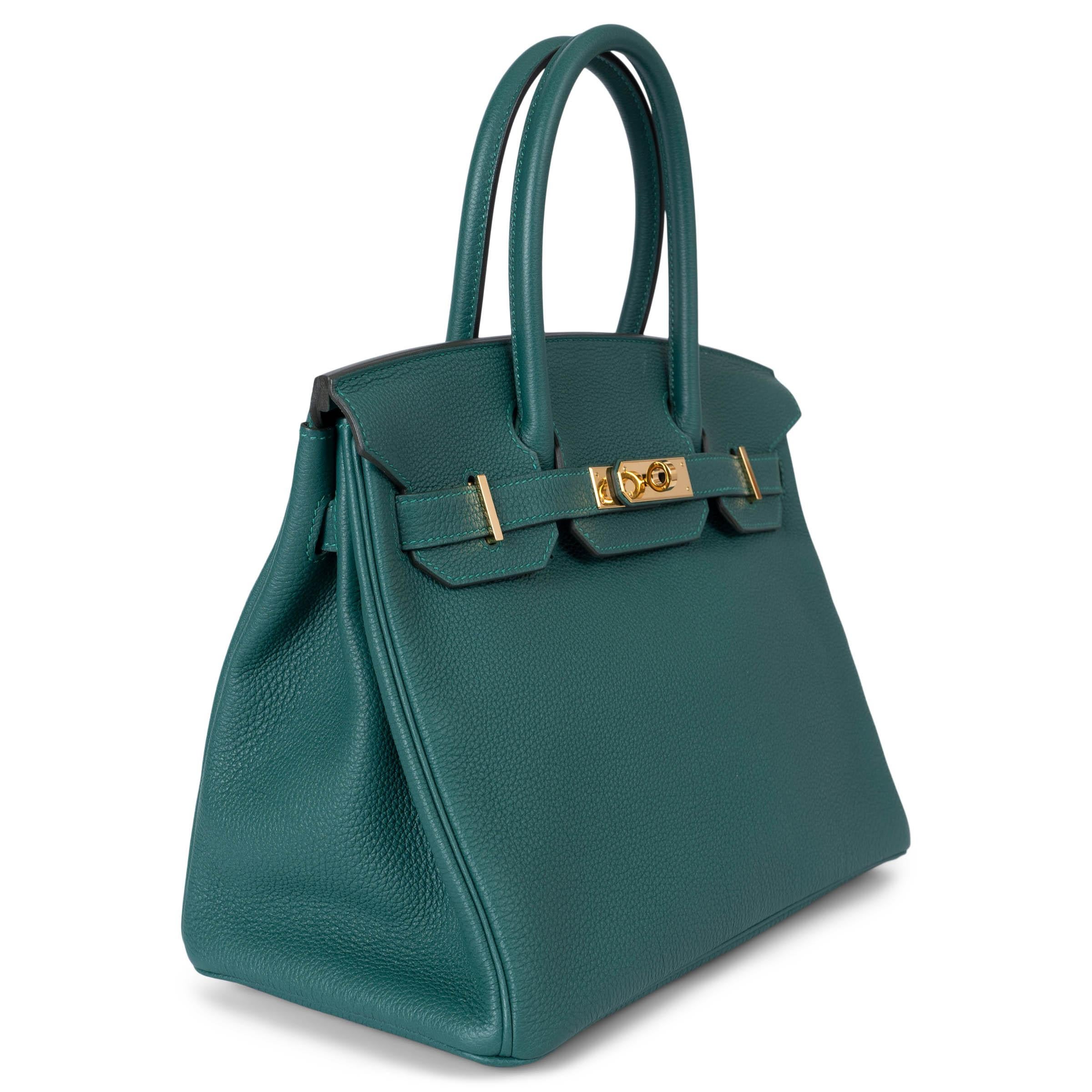 This 100% authentic Hermès Birkin 30 bag is crafted from stunning jewel-toned Malachite green Veau Togo leather, paired beautifully with gold-plated hardware. The rich green hue evokes a sense of luxury, making it a true statement piece. Lined in