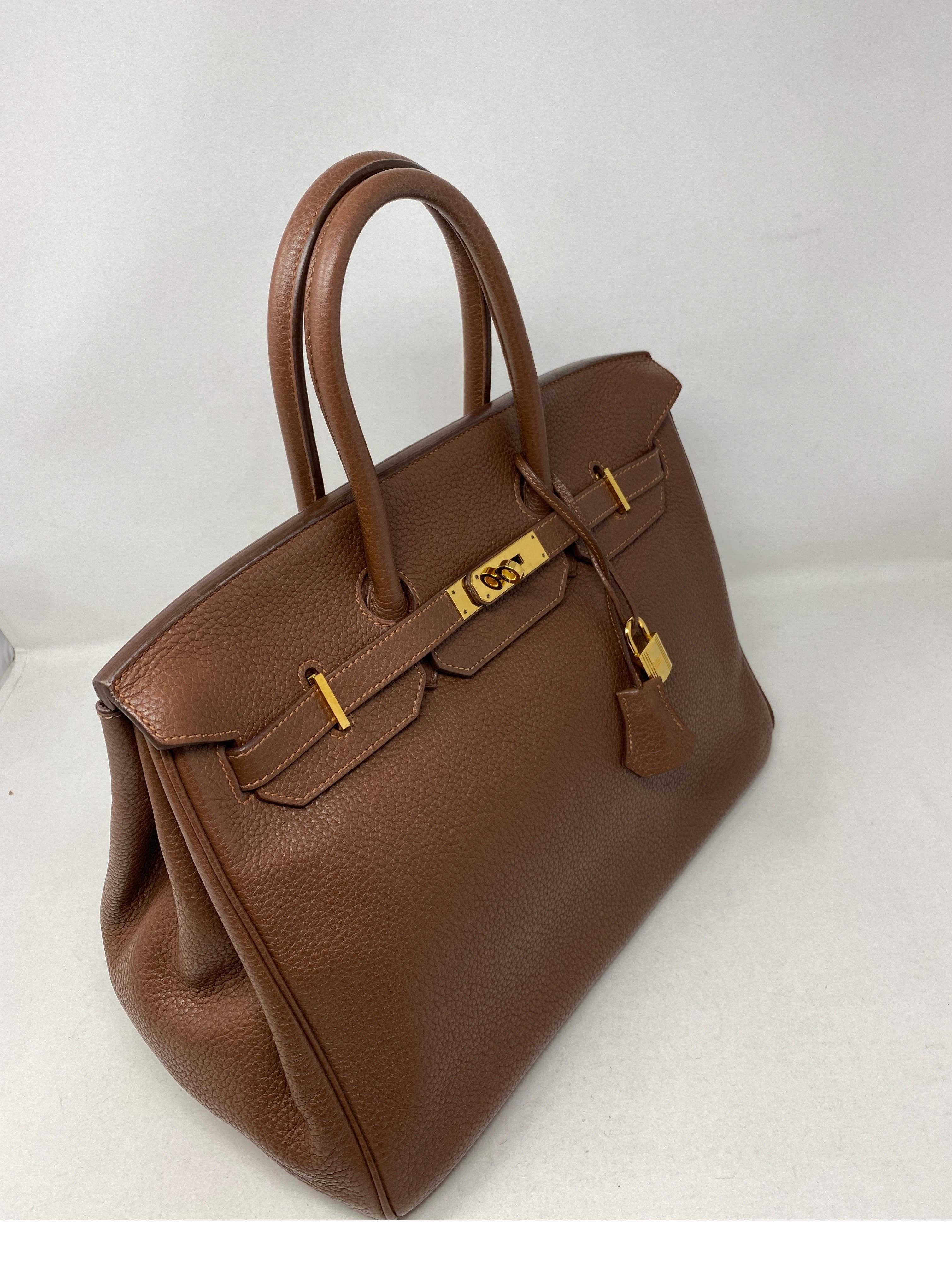 Hermes Maroon D'Inde Birkin 35 Bag. Clemence leather. Gold hardware. #O stamp from 2011. Good condition. A shade darker than gold color on Hermes color chart. Beautiful neutral color. Includes clochette, lock, keys, and dust cover. Guaranteed