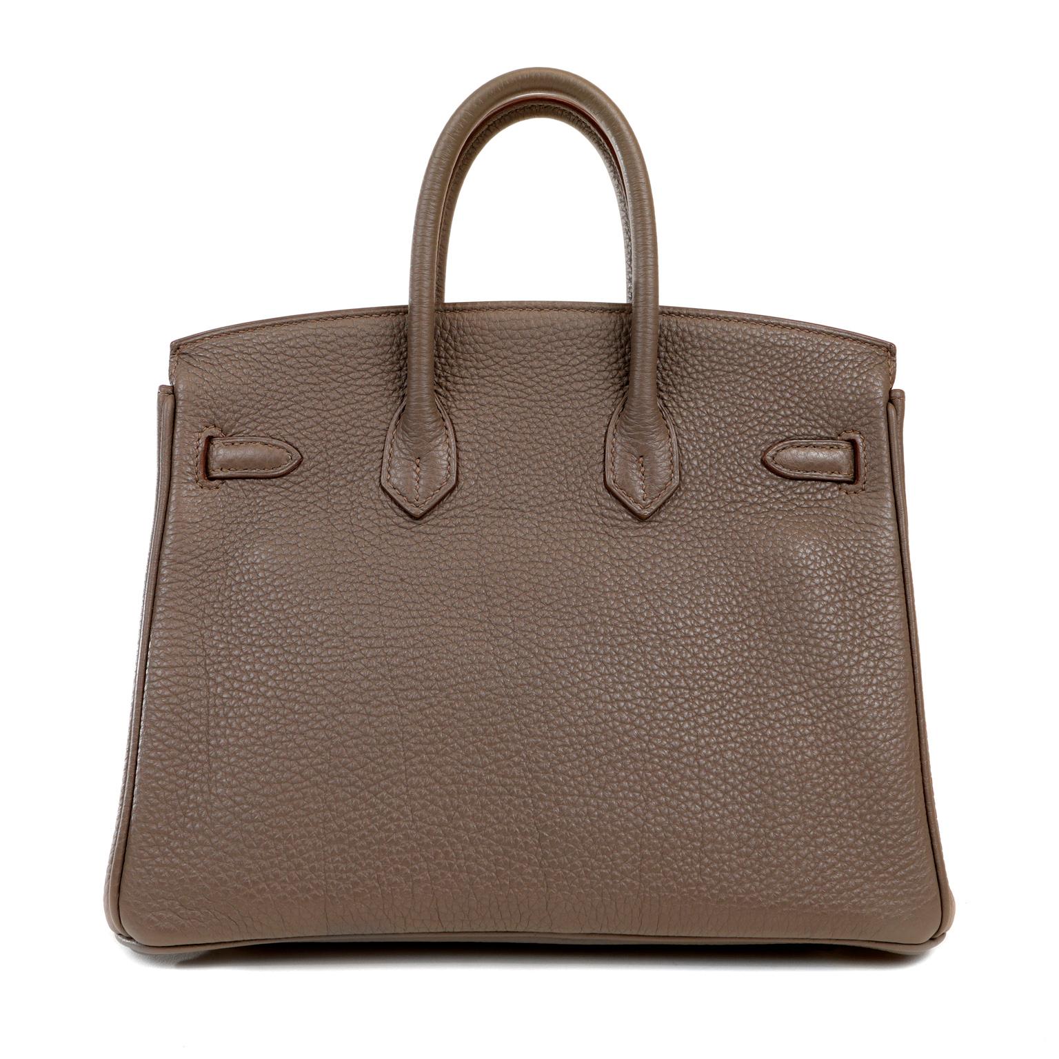 This authentic Hermès Matte Grey Togo 25 cm Birkin is in pristine condition with the protective plastic on much of the hardware.    Hand stitched by skilled craftsmen, wait lists of a year or more are common for the Hermès Birkin. They are
