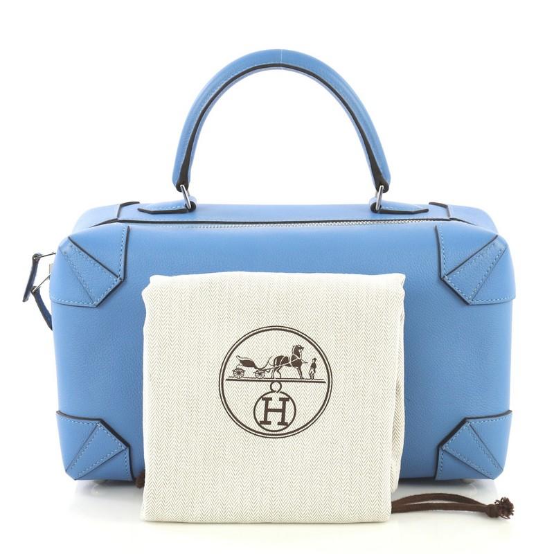This Hermes Maxibox Handbag Evercolor 29, crafted in Bleu Paradis blue Evercolor leather, features a rolled leather handle and palladium hardware. Its zip closure opens to a Bleu Paradis blue Evercolor leather interior with slip pocket. Date stamp