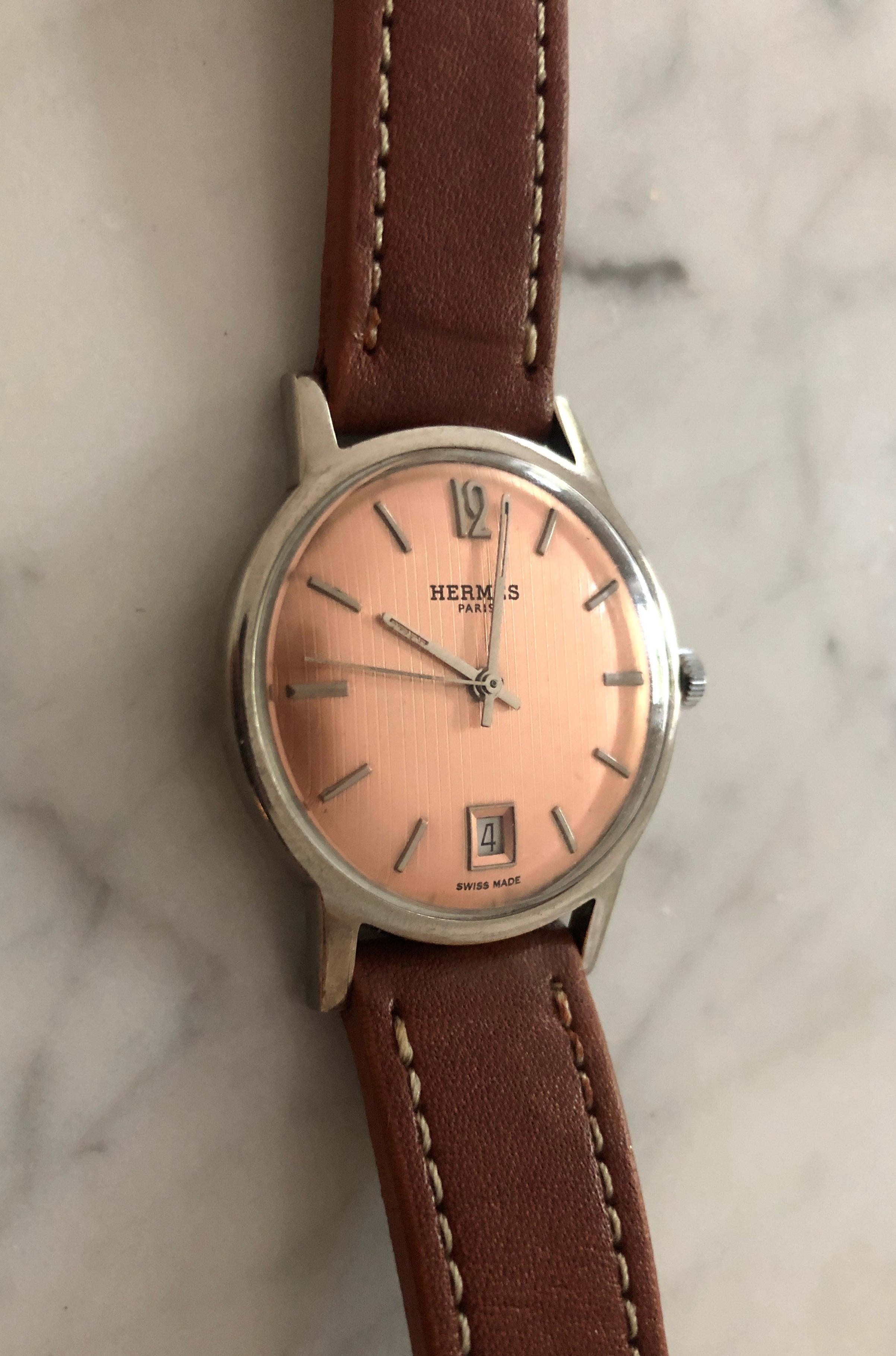 Vintage, one-of-a-kind, beautiful Champagne Rosé dial mechanical Hermès watch. Works great  when wound.

Brand: Hermes Paris
Age: circa 1954
Gender: Men's.
Dial: Champagne Rosé -Guilloche. Chromed markers and chromed hands. Central Seconds Hand.