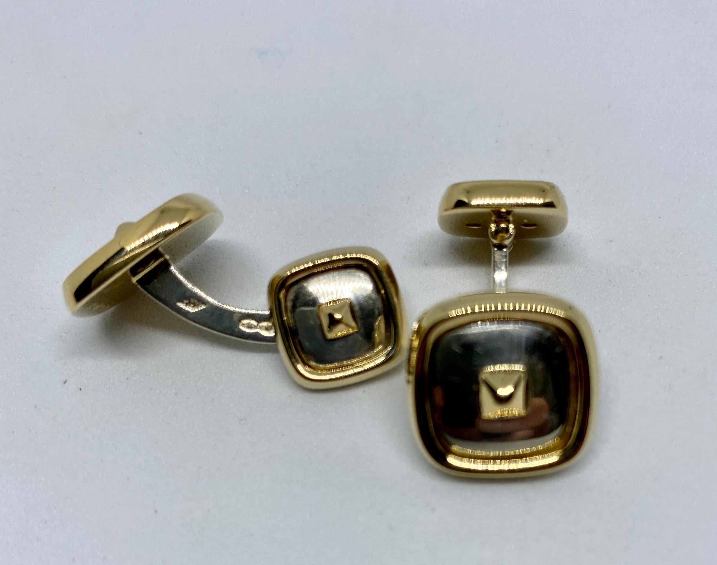Classic, beautifully made cufflinks in sterling silver and yellow gold by Hermès Paris. A contemporary design featuring the Médor motif created by the House of Hermès in 1927, these cufflinks are simultaneously classic and modern, casual and