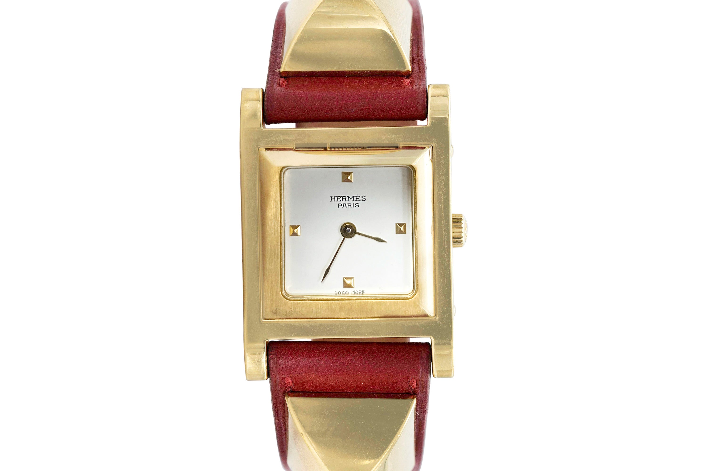 Hidden white face watch underneath the center dome, on a red leather band.
Signed by Hermes.