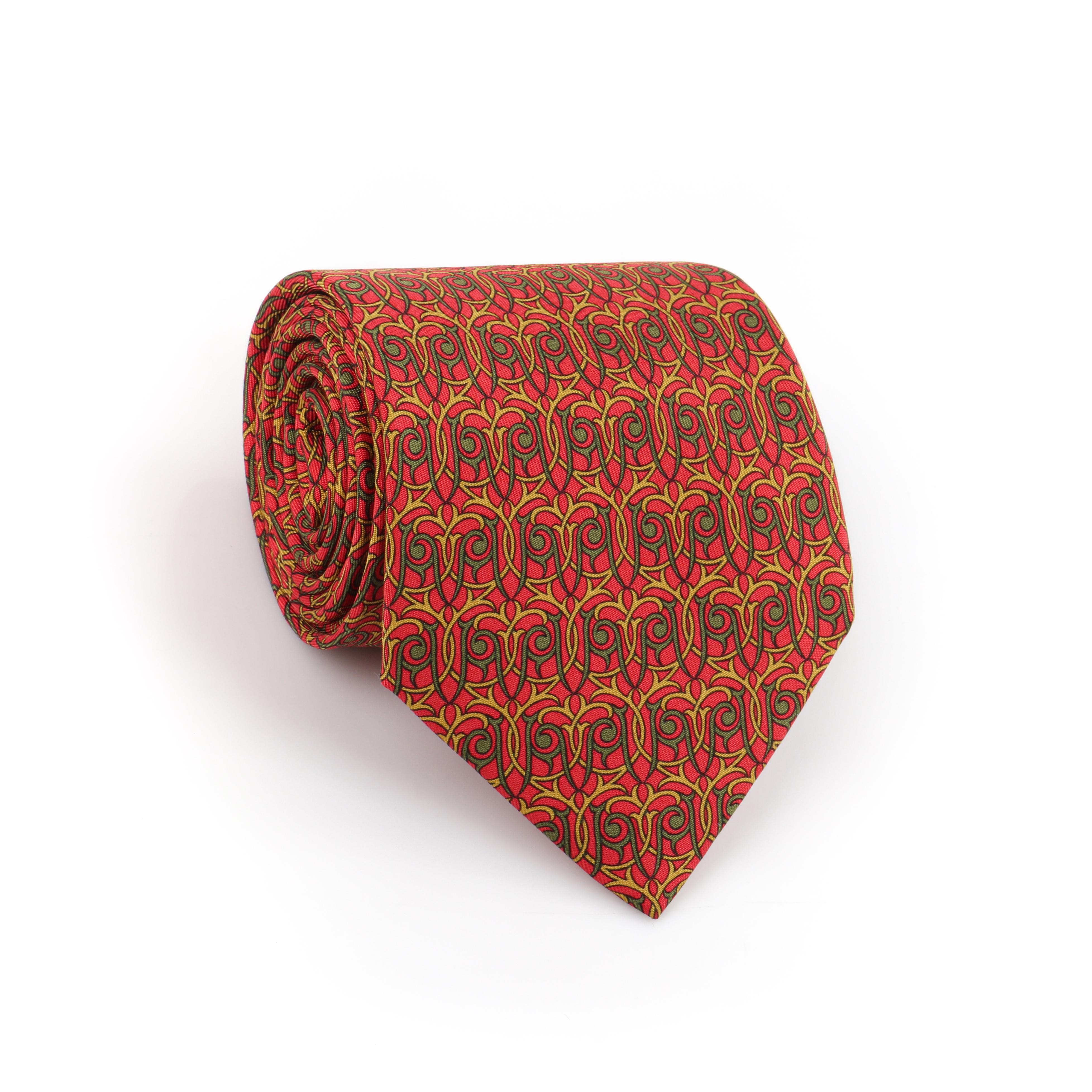 HERMES Men’s 7928 MA 5-Fold Red Green Yellow Intertwine Geometric Print Neck Tie
 
Brand / Manufacturer: Hermes
Style: Neck tie
Color(s): Shades of red, green, and yellow
Lined: Yes
Marked Fabric Content: 100% silk  
Additional Details / Inclusions:
