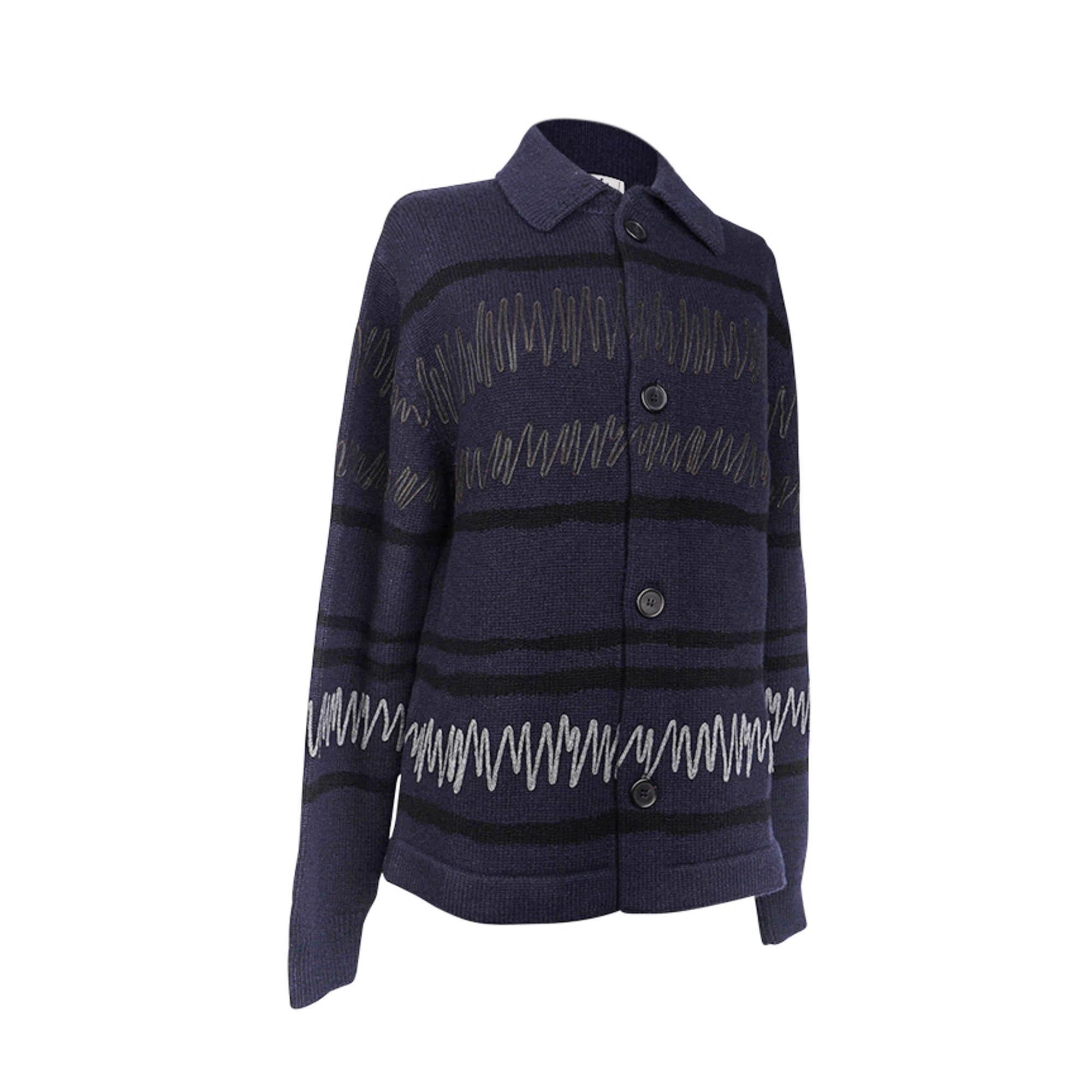 Mightychic offers a  rare Hermes Men's collared cardigan featured in Marine with spaced black knit stripes.
Abstract design created with appliqued wool and lambskin strips of Etoupe and Gris in the front.
Four (4) button front.
Ribbed bottom and