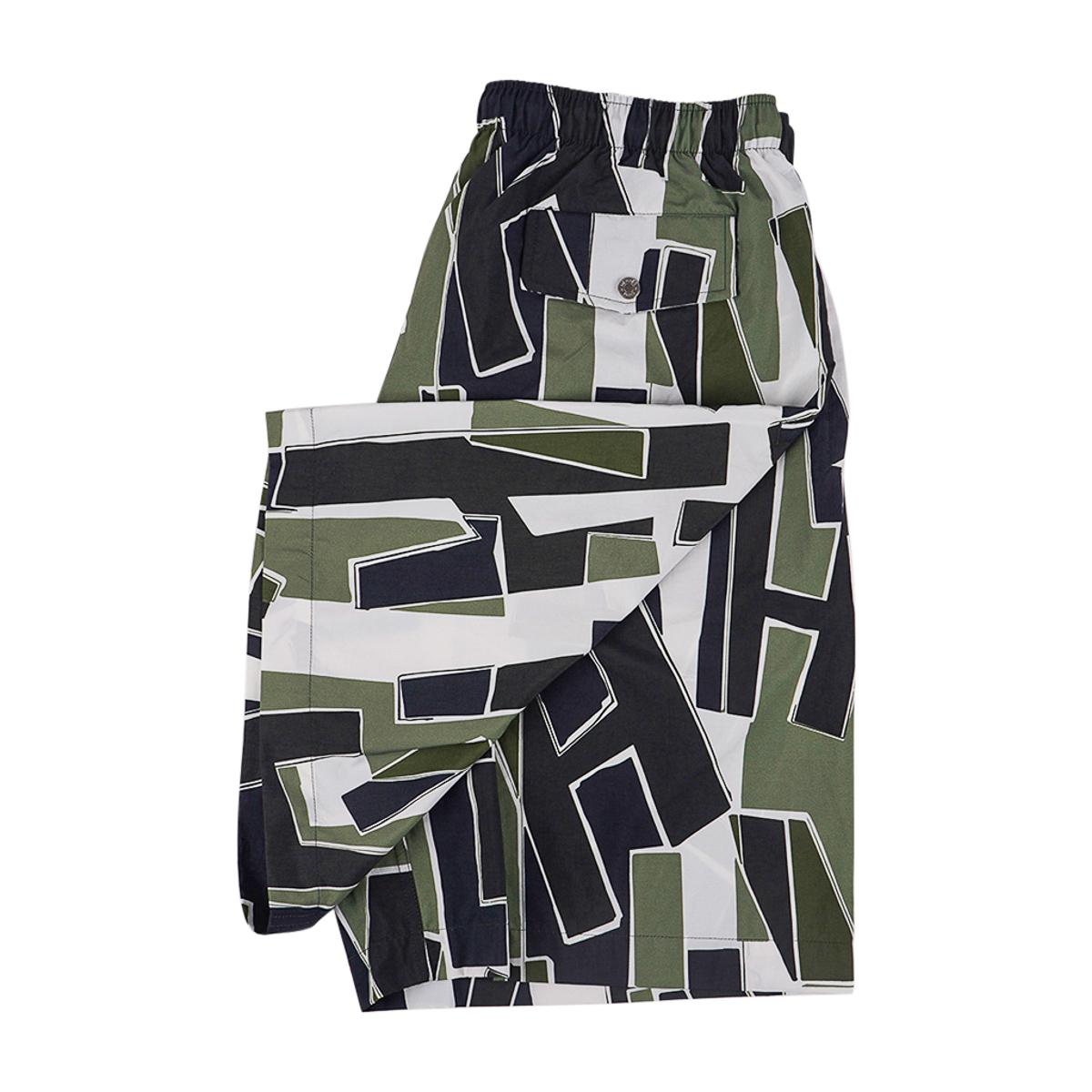 Hermes long swim trunks featured in Decoupage de H print.
Colorway is Vert-de-Gris.
Trunks have an elastic waistband with drawsting for adjustment.
2 side pockets and 1 rear pocket with Clou de selle snap closure.
Fabric is nylon canvas.
Made in