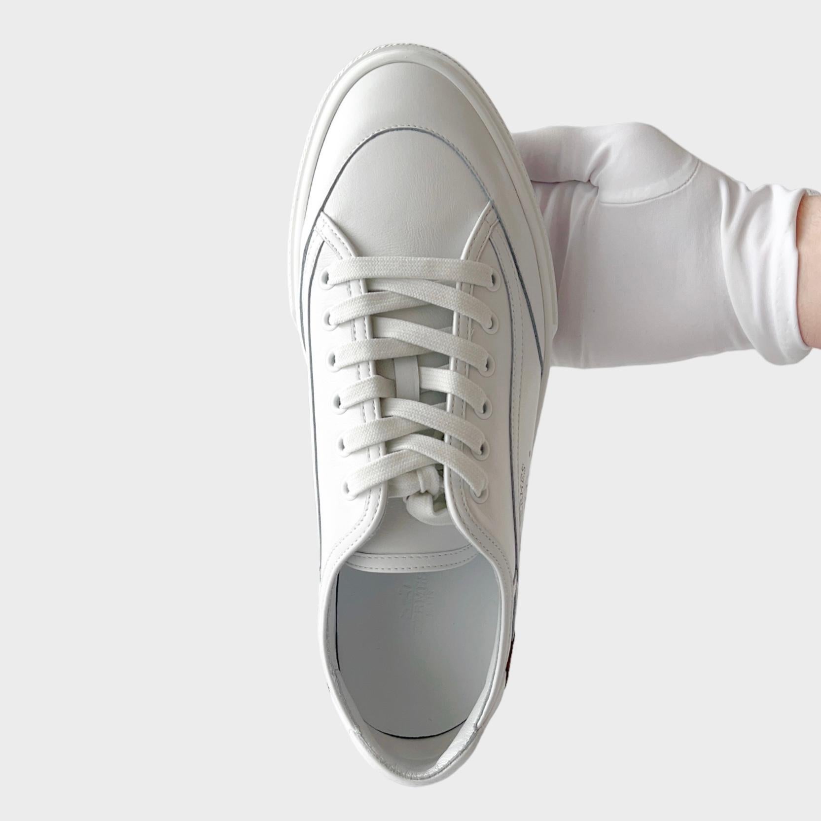 Shop the Hermes Get Sneaker, a comfortable everyday classic sneaker. This pair of Men's Get Sneakers comes in White complimented by Gold leather detailing at the heel. It features a new 'H' emblem on the side. The sneaker comes in calfskin. This is