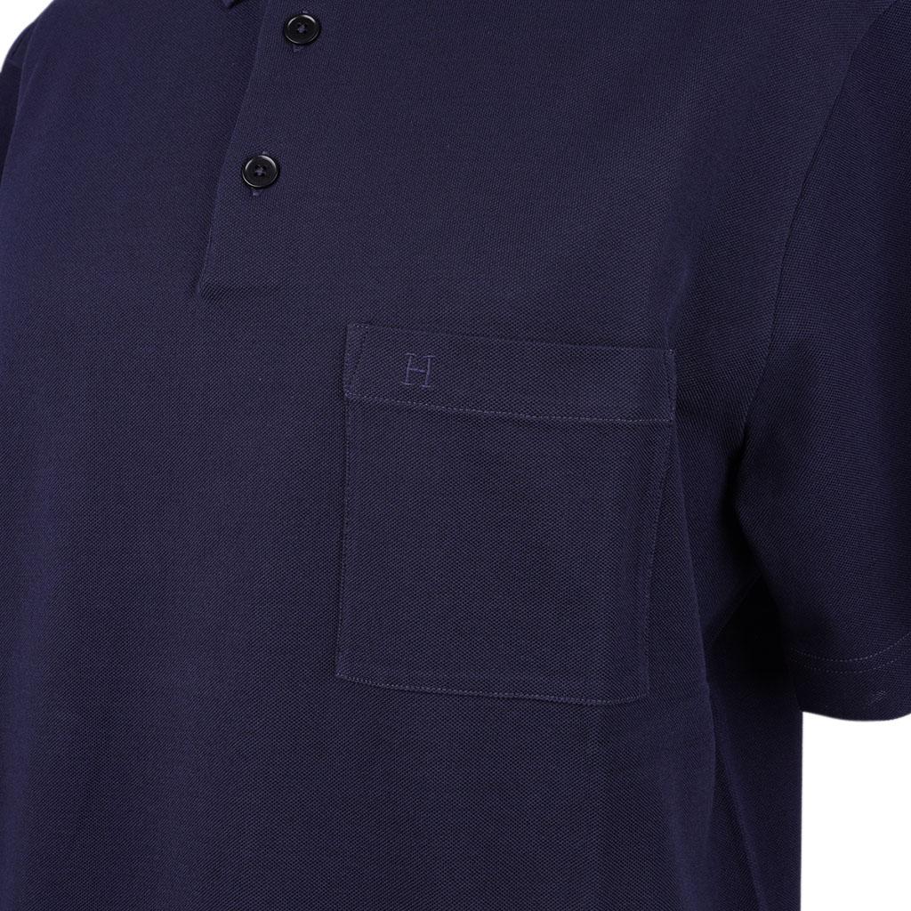 Hermes H Embroidered Polo shirt featured in rich Marine.
Embroidered H on pocket.
3 mother of pearl buttons.
Short sleeve shirt.
Classic style and effortless elegance.
Fabric is cotton.
NEW or NEVER WORN.
final sale

SIZE L

TOP MEASURES:
LENGTH