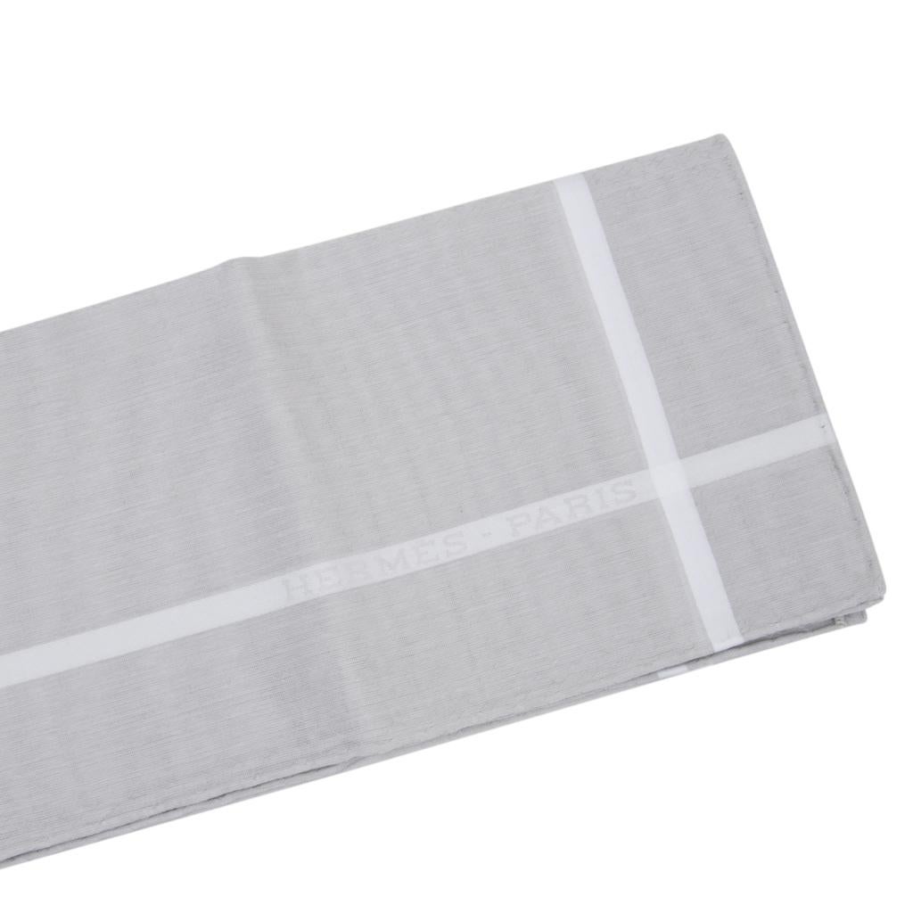 Guaranteed authentic Hermes Jacquard D'H handkerchief set in Gris Clair and Rose Clair.
Beautiful pale shades of gray and pink with white accent in light jacquard cotton. 
Signature hand-rolled edges. 
Presented in a charming Hermes box each with