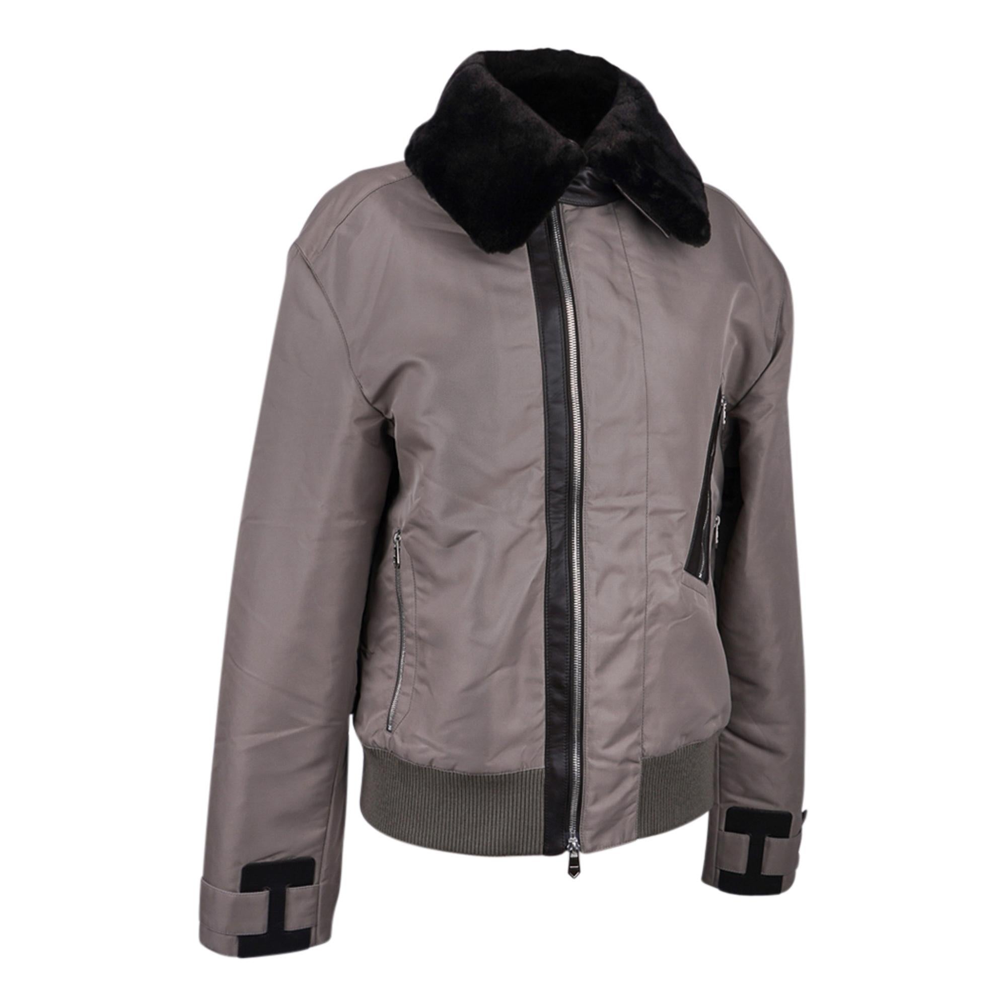 Mightychic offers an Hermes limited edition men's nylon and leather off center front zip jacket featured in Greige
Jacket has Black leather trim at front zip and H leather trim at cuffs.
Detachable Black Sheared Beaver collar.  Raised collar is