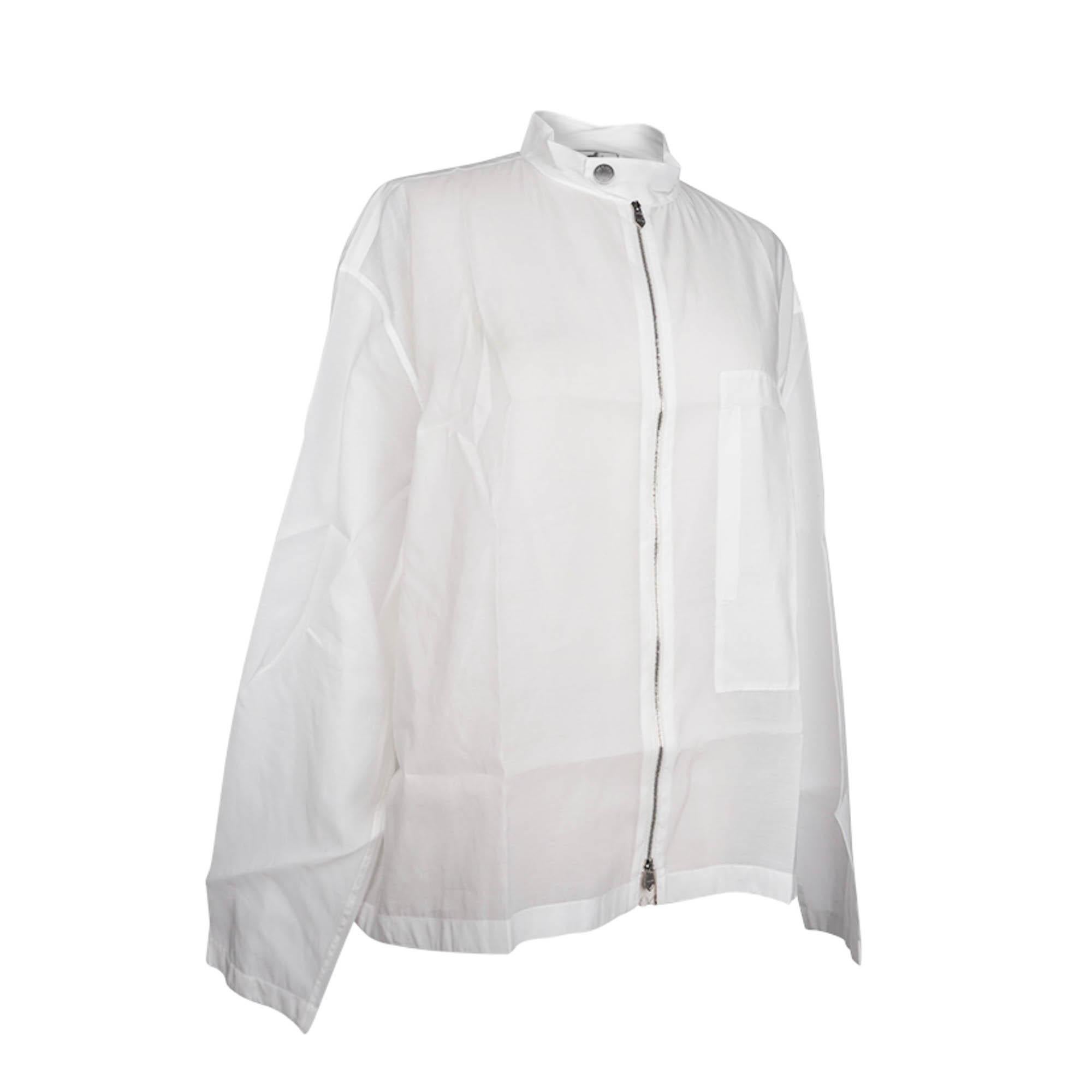 Mightychic offers an Hermes rare limited edition reversible men's casual jacket featured in White.
A long sleeve jacket made of light, semi-sheer fabric.
A large shaped interior pocket on the left side.
The Mandarin collar has one Clou de Selle snap
