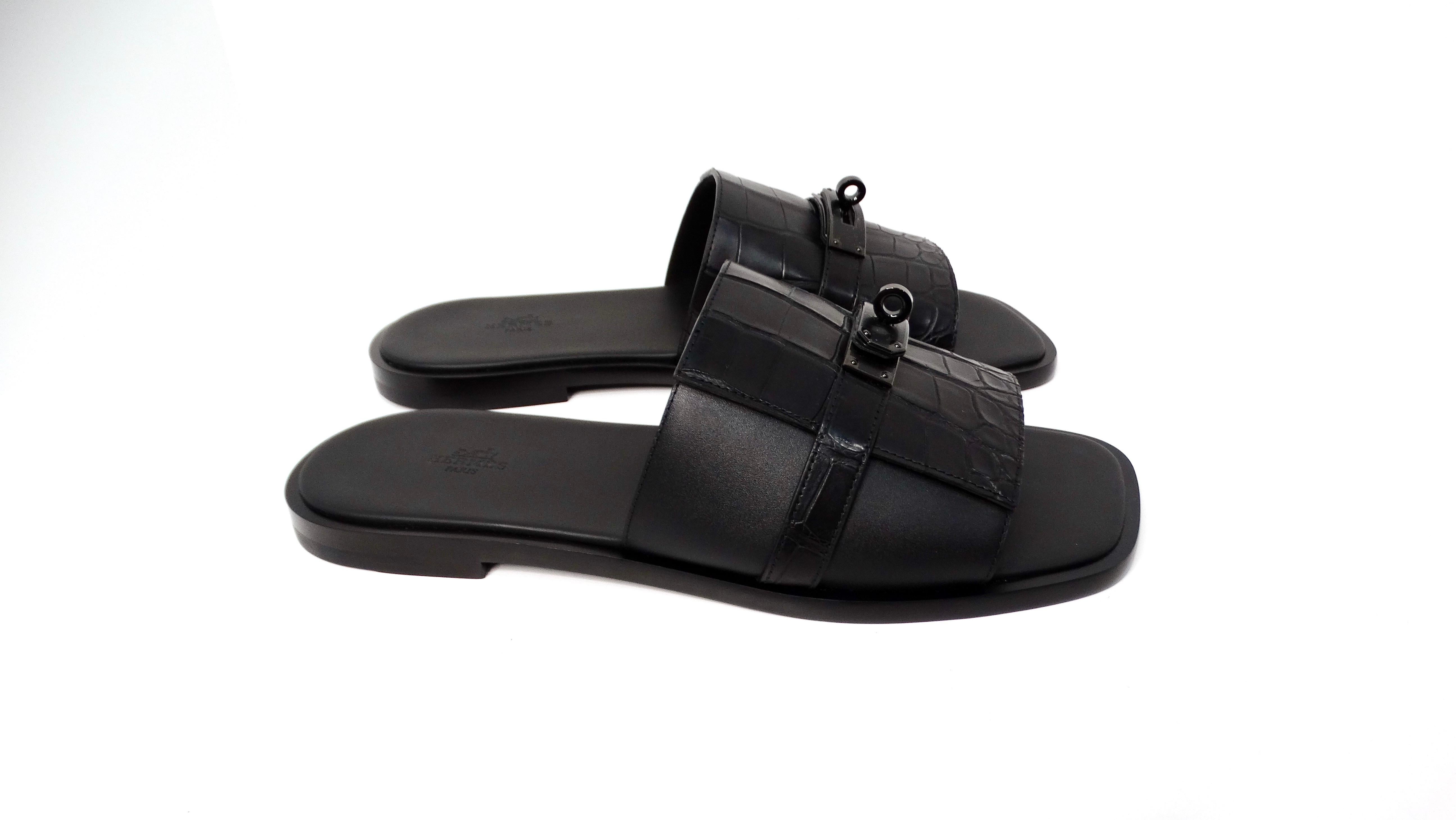Elevate your footwear collection with the Hermes Custom Men's Gabriel Black on Black Alligator Leather Slide Sandals, a timeless piece that effortlessly merges luxury and comfort. Crafted from exquisite black alligator leather, these sandals