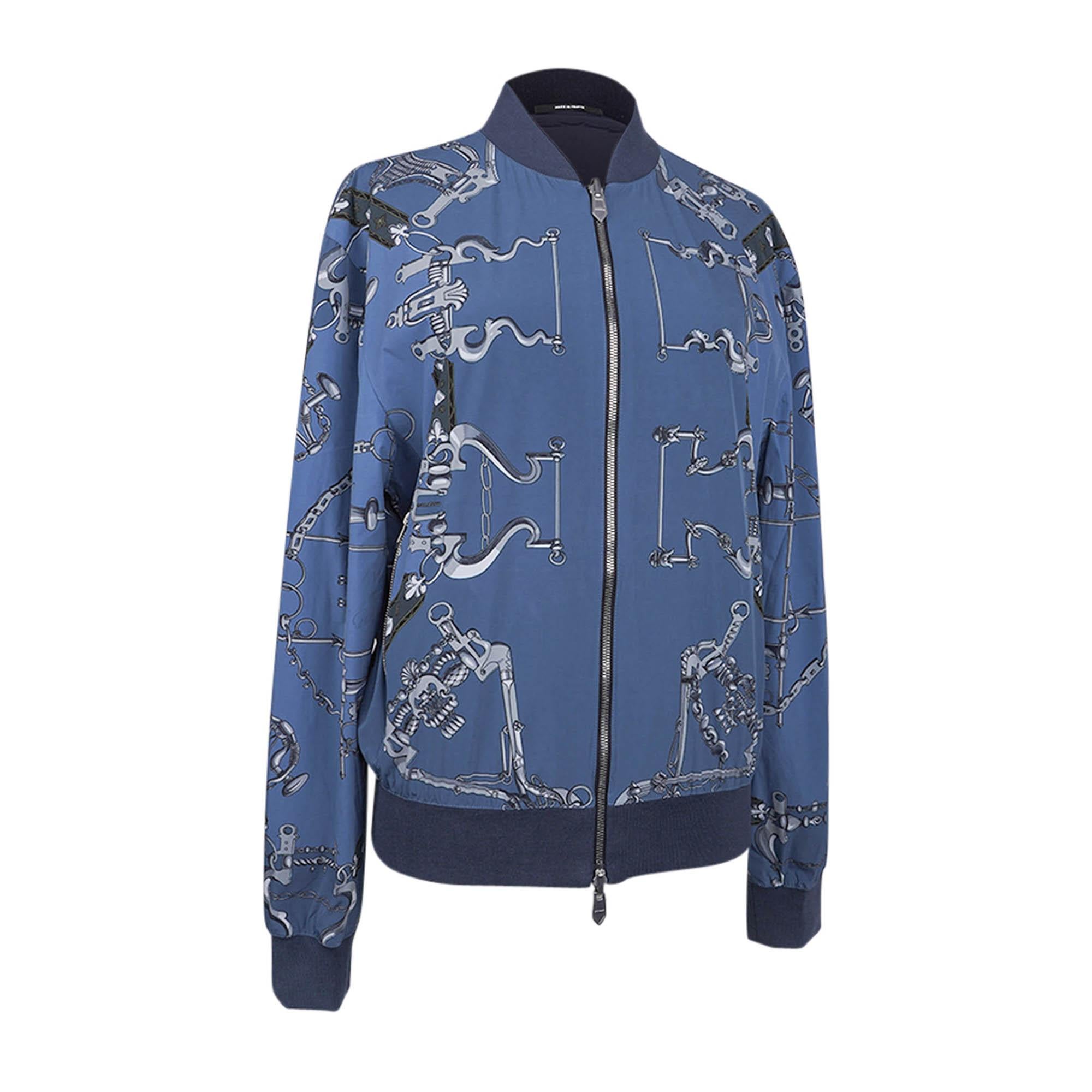 Mightychic offers an Hermes chic scarf print reversible silk men's windbreaker bomber style jacket.
The Blue and Grey rare Mors et Gourmettes print reverses to solid Marine.
Double zipper for closure.
Jacket has 2 exterior and 2 interior zip pockets