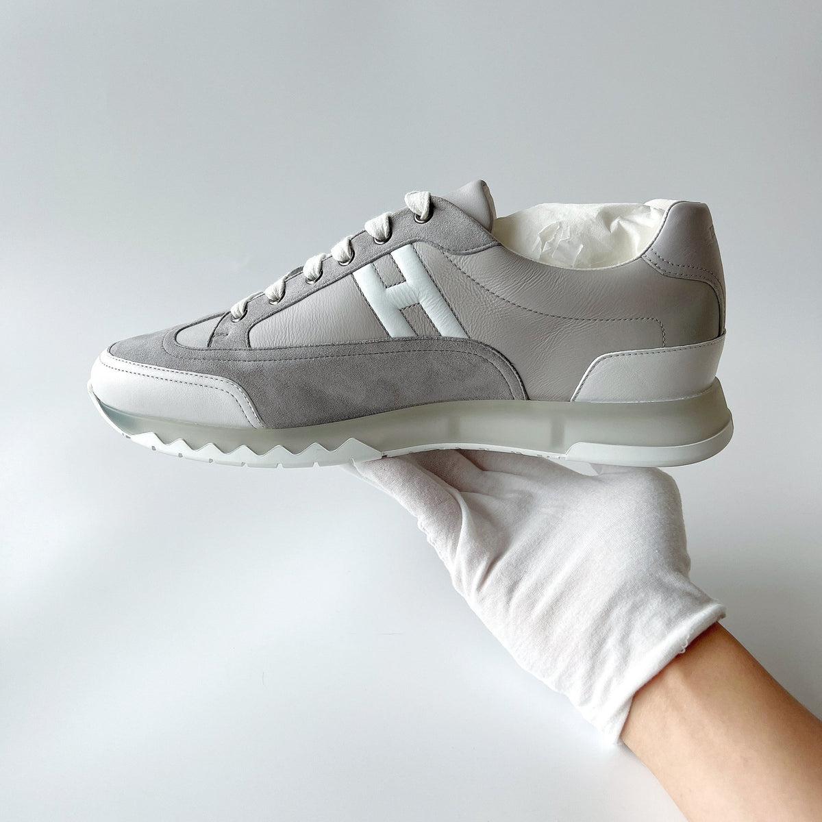 Shop this comfy pair of Hermes Mens Trail Sneakers In Grey And White. They are made from a mix of calfskin and suede goatskin. They are true to size and have a super comfortable fit for everyday outings. This pair of trail sneakers comes in EU size