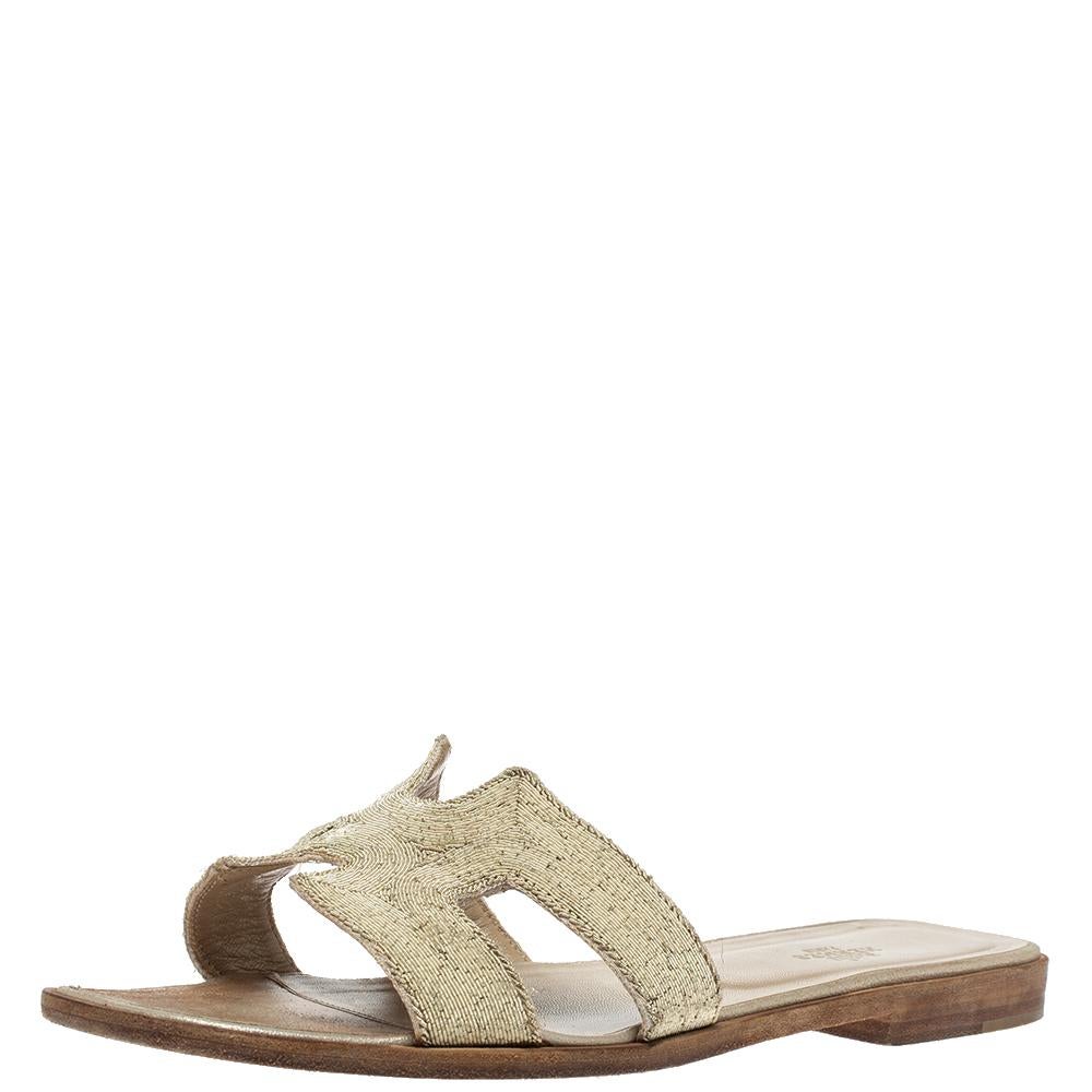Put your best foot forward this season in these pretty Hermes sandals. These metallic pale gold Oran sandals have twisted metal thread on the iconic H. Leather insoles are meant to provide comfort at every step. These sandals are sure to attract